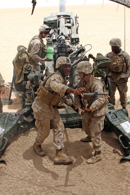 Marine Corps cannon crewmen, Bravo Battery, Battalion Landing Team 1st Battalion, 9th Marine Regiment, 24th Marine Expeditionary Unit endure unforgiving heat as they fire more than 200 rounds from their M777 A2 155 mm Howitzers during an artillery live fire range. This is only one of several training exercises the Marines of the 24th MEU have completed during their deployment throughout the Middle East.