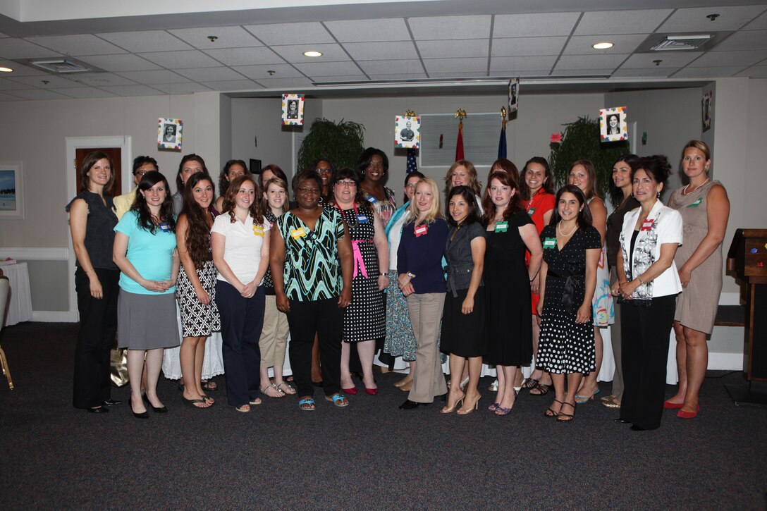 Volunteers with the Navy-Marine Corps Relief Society pose for a group photo during the NMCRS Volunteer Awards and Recognition Ceremony aboard Marine Corps Base Camp Lejeune, May 12.  Personnel from the NMCRS and service members aboard the base gathered together to recognize these volunteers for their time and efforts in providing financial, educational, medical and other assistance to Marines and sailors in a time of need.