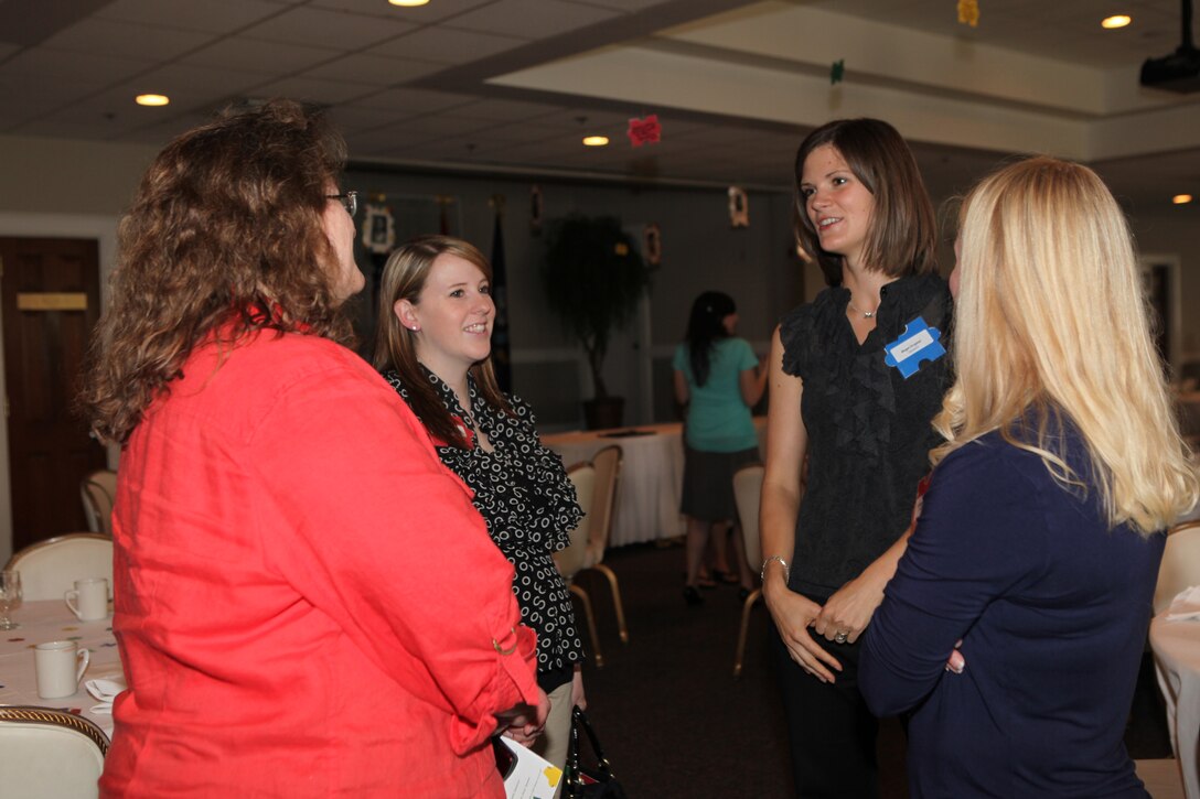 Volunteers with the Navy-Marine Corps Relief Society socialize during the NMCRS Volunteer Awards and Recognition Ceremony aboard Marine Corps Base Camp Lejeune, May 12.  Personnel from the NMCRS and service members aboard the base gathered together to recognize these volunteers for their time and efforts in providing financial, educational, medical and other assistance to Marines and sailors in a time of need.