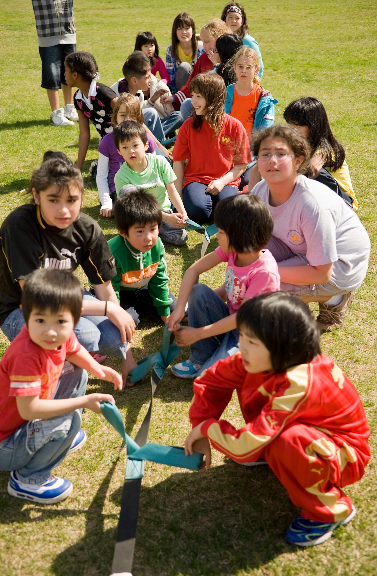 Children from Misawa Air Base Sollars Elementary School student council program and  children from Japan’s Shichinohe Bikoh-En orphanage await the start of tug-of-war competition, May 8, during a sports day exchange at the school. Sollars students host activities at the orphanage every year; however, the event marked the first time Japanese student came to the base. (U.S. Air Force/Senior Airman Jessica Lockoski)