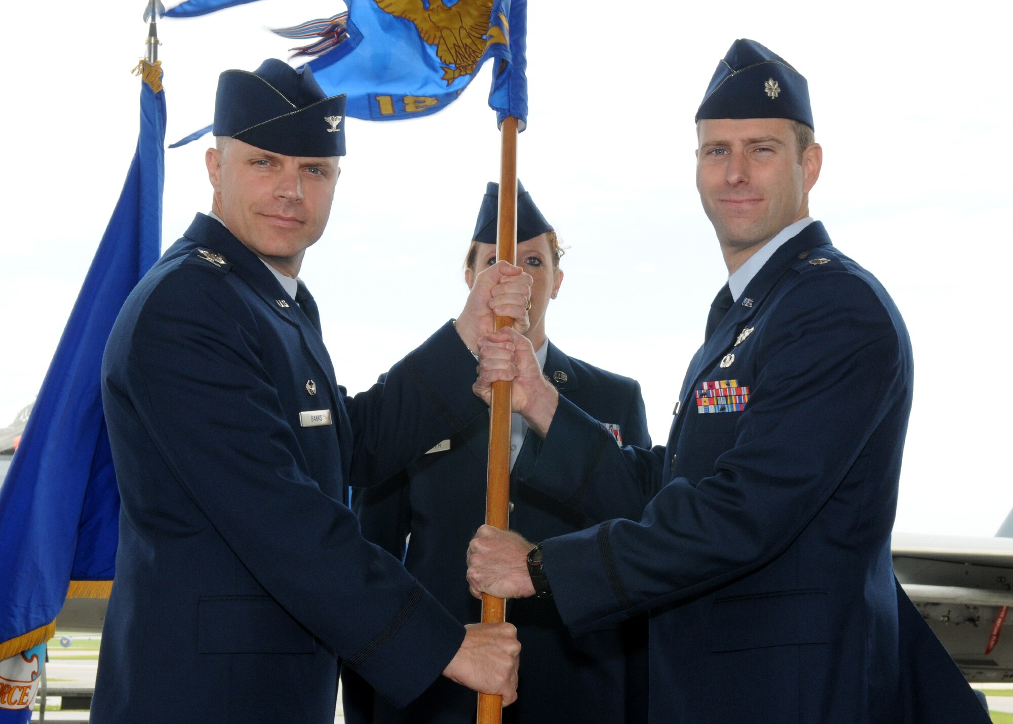 Lt. Col. David Mineau accepts the 18th Operations Support Squadron flag from Col. Ronald Banks, 18th Operations Group commander, during a change of command ceremony May12, 2010.  (U.S. Air Force photo/Staff Sgt. Chris Hummel)        