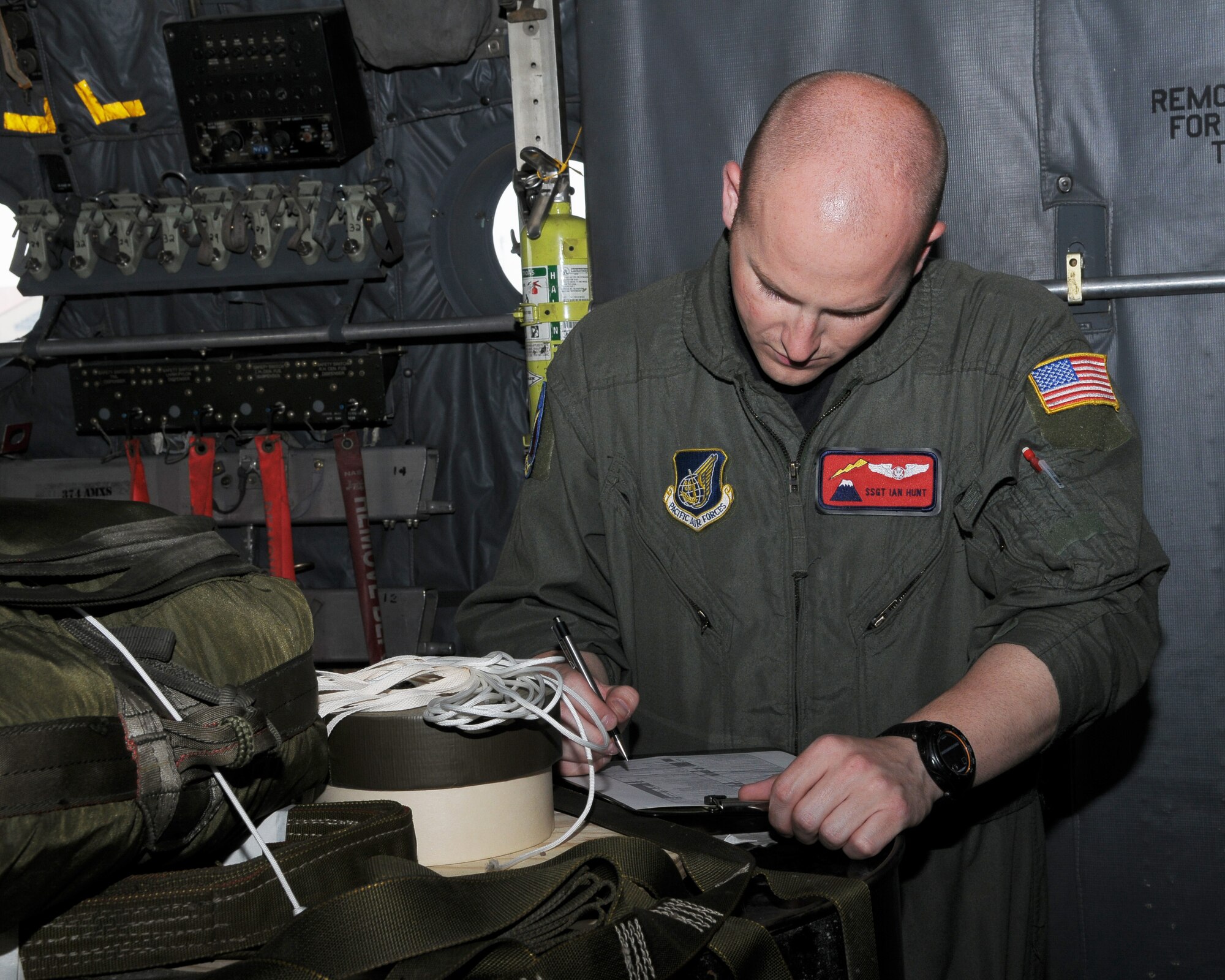 YOKOTA AIR BASE, Japan -- Staff Sgt. Ian Hunt, 374th Operations Support Squadron loadmaster, goes through an inspection checklist May 5 during a Joint Air Delivery Inspection. (U.S. Air Force photo/Airman 1st Class Sean Martin)