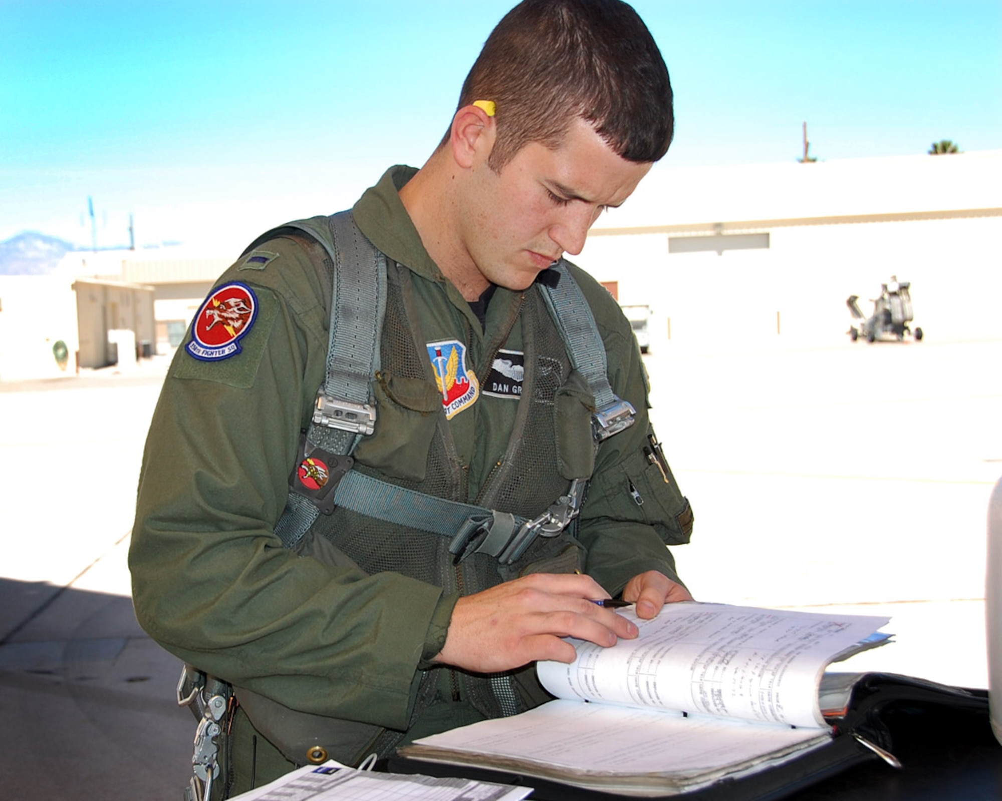 Prior to his flight May 3, 1st Lt. Dan Griffin, a pilot from the 358th Fighter Squadron, reviews maintenance records for his A-10C aircraft. He was on his way to the Barry M. Goldwater range to fire the A-10C’s 30mm Gatling gun for the first time as part of the A-10C Pilot Initial Qualification course curriculum. Upon completion of this course he will be a fully qualified A-10C pilot. (U.S. Air Force photo/Capt. Stacie N. Shafran)