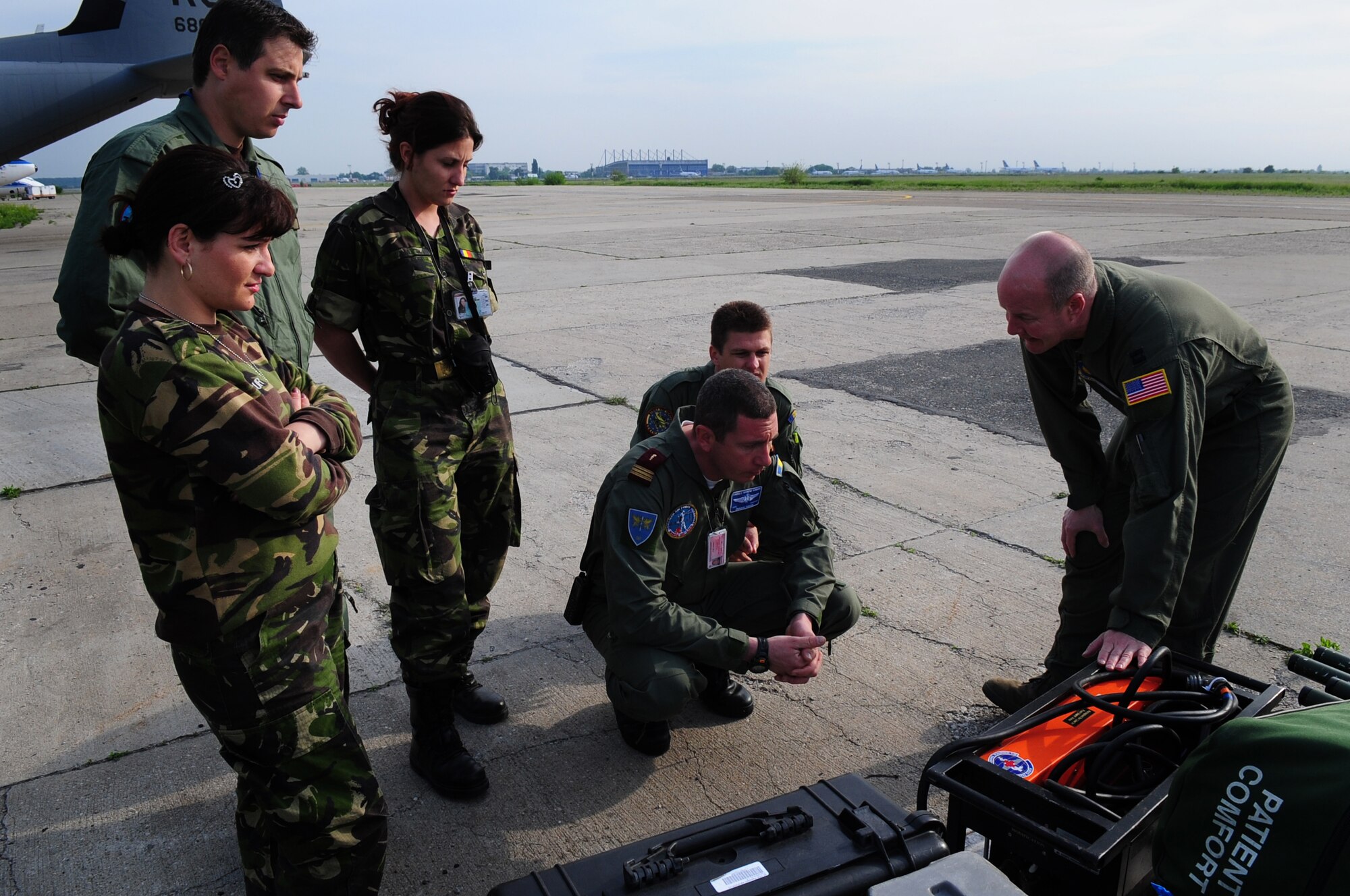 U.S. Air Force Capt. Erskine Cook Jr., 86th Aeromedical Evacuation Squadron flight nurse, familiarizes Romanian Air Force medical evacuation counterparts with equipment and procedures used to evacuate patients during the joint exercise Carpathian Summer, Otopeni Airlift Base, Romania, May 12, 2010. Carpathian Summer 2010 was an exercise in which the Romanian Air Force invited members of the U.S. military to train with them on their soil and air space, to observe, firsthand, operations in action. This exercise was designed to build partnerships between these nations in an effort to work together more efficiently during real world scenarios. (U.S. Air Force Photo by Staff Sgt. Jocelyn Rich)