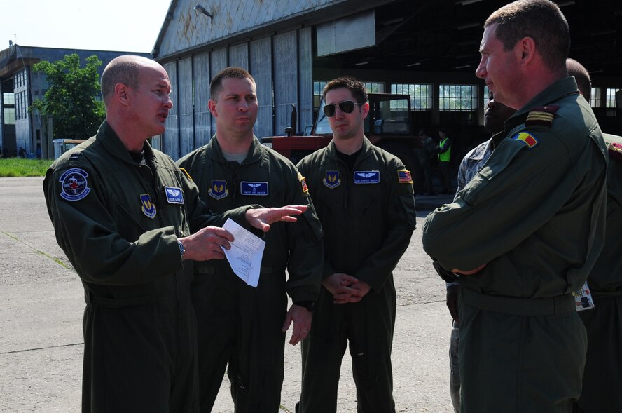 U.S. Air Force Capt. Erskine Cook Jr., 86th Aeromedical Evacuation Squadron flight nurse, discusses a plan for training with Romanian Captain Dragos Tudos, a flight surgeon, during the joint exercise Carpathian Summer, Otopeni Airlift Base, Romania, May 12, 2010. Carpathian Summer 2010 was an exercise in which the Romanian Air Force invited members of the U.S. military to train with them on their soil and air space, to observe, firsthand, operations in action. This exercise was designed to build partnerships between these nations in an effort to work together more efficiently during real world scenarios. (U.S. Air Force Photo by Staff Sgt. Jocelyn Rich)