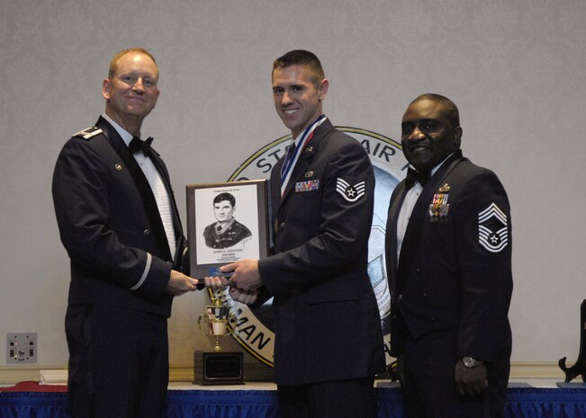 Col. Benjamin Wham, left, and Chief Master Sgt. Thomas Jackson, right, present Staff Sgt. Jonathan Houghton with the John L. Levitow Award during the Airman Leadership School Class 10-D graduation at the Charleston Club here May 6, 2010. The award is given for a student's exemplary demonstration of excellence both as a leader and a scholar. Colonel Wham is the 628th Mission Support Group commander, Chief Jackson is the 628th Mission Support Group command chief and Sergeant Houghton is a Communication, Navigation, Mission Systems Journeyman with the 437th Aircraft Maintenance Squadron on loan to the 628th Air Base Wing protocol office. (U.S. Air Force Photo/Airman 1st Class Lauren Main)