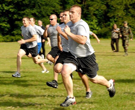 Airmen from the 628th Civil Engineer Squadron sprint to the finish line during the Guns vs. Hoses competition at the base picnic grounds on Joint Base Charleston, S.C., May 7, 2010. This year marked the second annual competition held between the 628th Security Forces Squadron and the 628th Civil Engineer Squadron. The competition consisted of a number of events to include a relay race and a push-up and sit-up competition. The competition is part of Police Week which was established by John F. Kennedy in 1982. (U.S. Air Force Photo/Airman 1st Class Lauren Main)