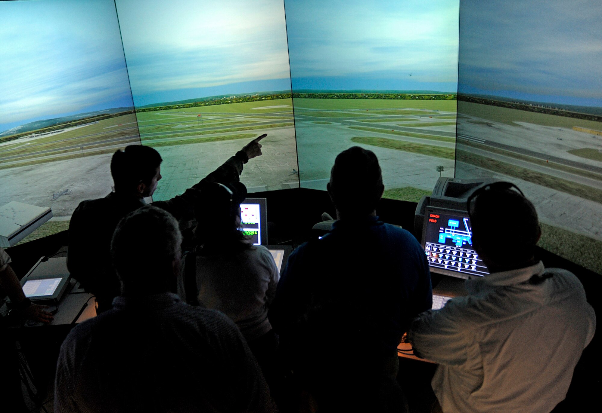 Participants of the Joint Civilian Orientation Course (JCOC) watch a air traffic control simulator demonstration at the 23rd Special Tactics Squadron, Air Force Special Operations Command, Hurlburt Field, Fla. on April 29, 2010. JCOC is a Secretary of Defense sponsored program, which gives civilian community leaders the opportunity to learn about the military and national defense. (U.S. Air Force photo by Master Sgt. Russell E. Cooley IV)(Released)