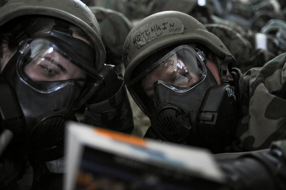 ELLSWORTH AIR FORCE BASE, S.D.—(Left) Senior Airman Jessica Tabor, 28th Medical Group medical administrator, reads her Airman’s manual with (right) Master Sgt. Randall Hotchkin, 28th Medical Group non commissioned officer in-charge of family health clinic, during the Phase II Operational Readiness Exercise, May 12. The Phase II ORE is designed to mimic a deployed environment and test the combat abilities of Ellsworth’s Airmen. (U.S. Air Force photo/Senior Airman Adam Grant) 