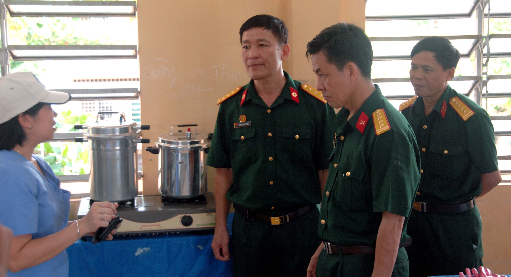Vietnamese People's Army Lt. Col. Doung Van Tham (left), Col. Le Van Hien and Col. Thai Minh Nhat, tour the dental clinic at the Tan Toi Village Elementary School in Can Tho, Vietnam, on May 12, 2010. Tran Thi Minh Huong, the dental program national coordinator for the East Meets West Foundation, also briefed the colonels on the procedures used to sterilize dental equipment. Operation Pacific Angel is a joint and combined humanitarian and civic assistance operation conducted in the Pacific area of responsibility to support U.S. Pacific Command's capacity-building efforts.
More than 50 U.S. military members are working alongside the Vietnamese military, non-governmental organizations and civil health personnel in medical and engineering efforts during the mission scheduled through May 15. (U.S. Air Force photo/ Capt. Timothy Lundberg)
