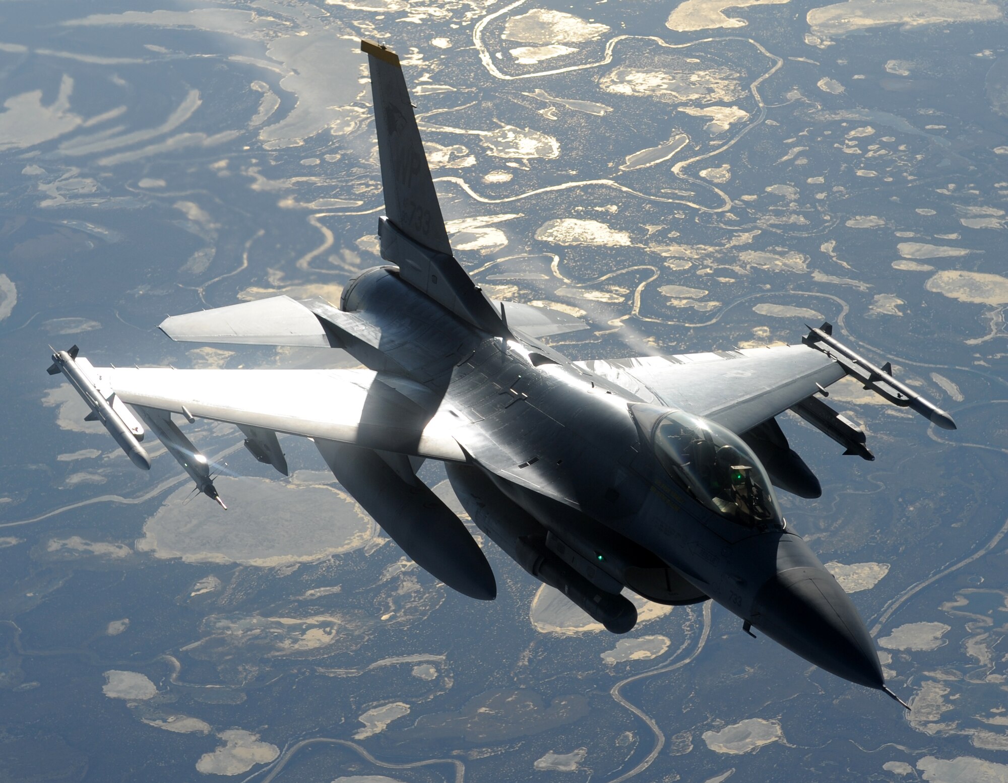 An F-16 Fighting Falcon flies away after receiving fuel from a KC-135 Stratotanker during a Coronet West May 8. A Coronet West is the title given to a group of jet fighters flying with necessary refueling capabilities and maintenance support, eliminating the need to land. The F-16 was flying to Kunsan, Korea. (U.S. Air Force photo by Staff Sgt. Suellyn Nuckolls)