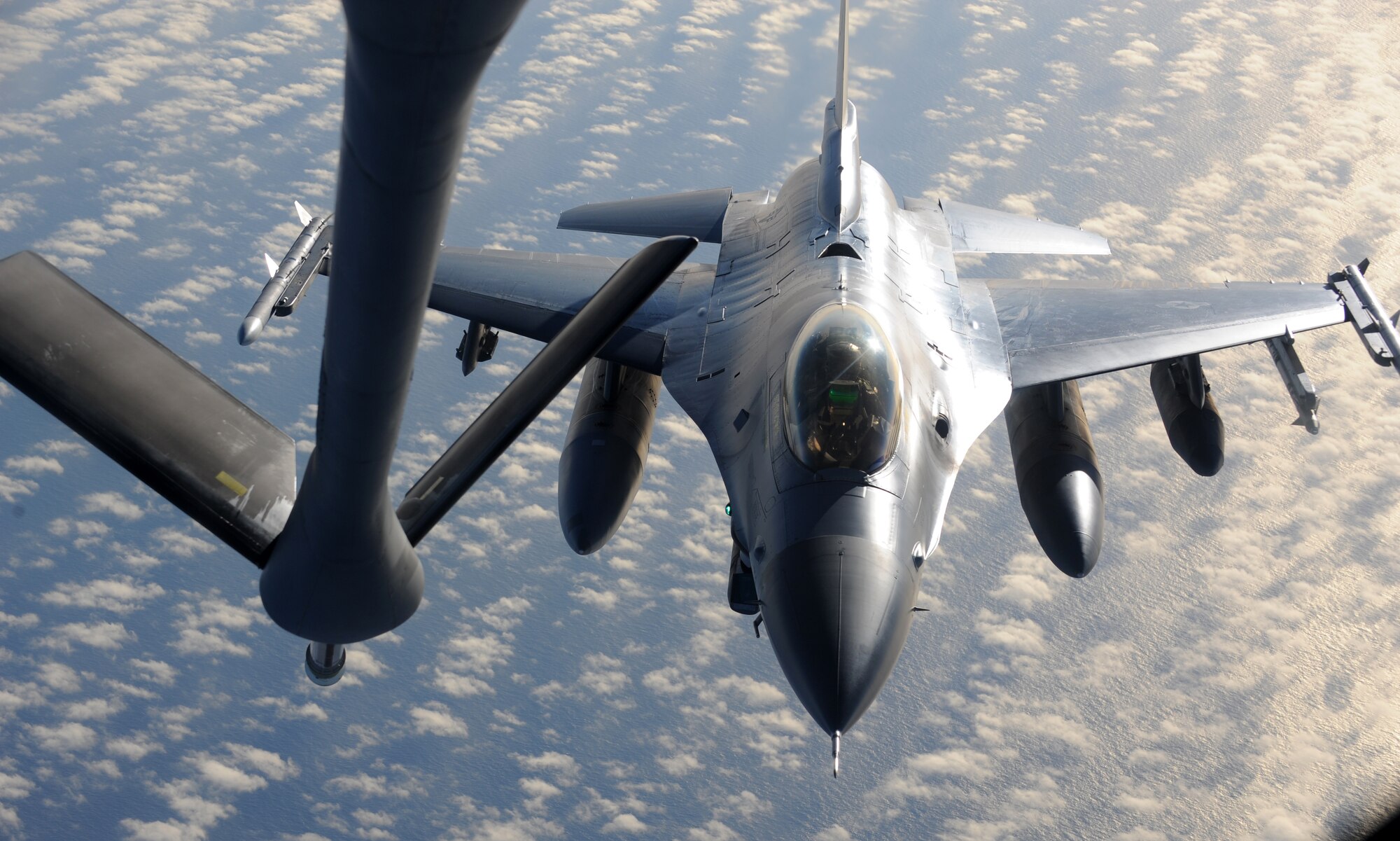 An F-16 Fighting Falcon approaches a KC-135 Stratotanker from the 319th Air Refueling Wing during a Coronet West May 8. A Coronet West is the title given to a group of jet fighters flying with necessary refueling capabilities and maintenance support, eliminating the need to land. The F-16 was flying to Kunsan, Korea. (U.S. Air Force photo by Staff Sgt. Suellyn Nuckolls)