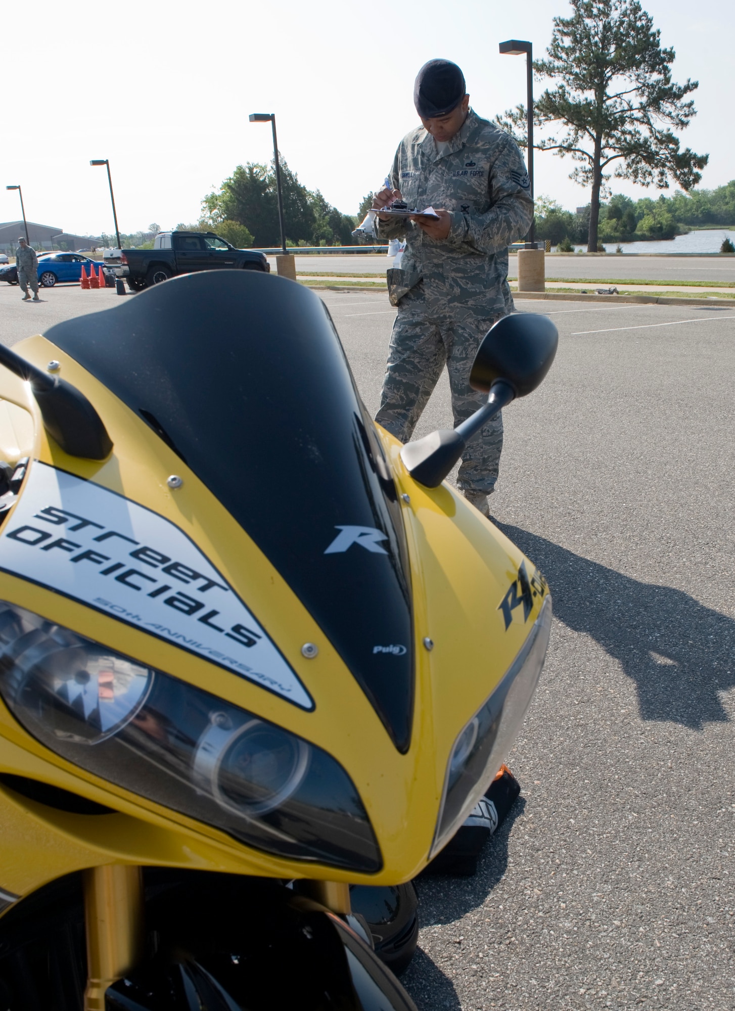 LANGLEY AIR FORCE BASE, Va. -- Staff Sgt. John Sewell, 633d Security Forces investigator,  inspects a motorcycle before the ride  May 12.  The motorcycle ride was part of National Police week to remember the brave police officers who have fallen to protect us at home. (U.S. Air Force photo/Senior Airman Zachary Wolf)