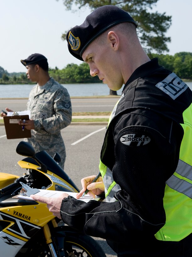LANGLEY AIR FORCE BASE, Va. -- Staff Sgt.Brandon Phelps, 633d Security Forces Squadron unit training instructor, and Staff Sgt. John Sewell, 633d Security Forces investigator,  inspect the motorcycles before the ride  May 12.  The motorcycle ride was part of National Police Week, a celebration in honor of law enforcement officers who lost their lives in the line of duty. (U.S. Air Force photo/Senior Airman Zachary Wolf)