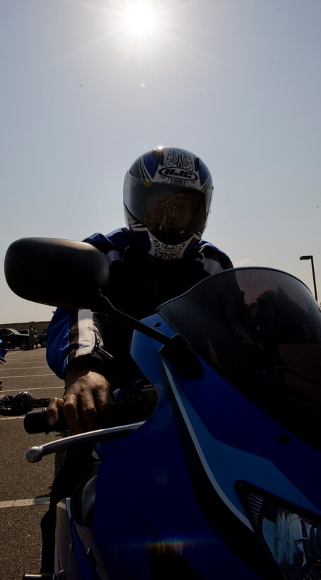 LANGLEY AIR FORCE BASE, Va. -- Staff Sgt. Marvin Kelker, 633d Security Forces Squadron patrolman, prepares his motorcycle May 12. The motorcycle ride was part of National Police Week, a celebration in honor of law enforcement officers who lost their lives in the line of duty. (U.S. Air Force photo/Senior Airman Zachary Wolf)