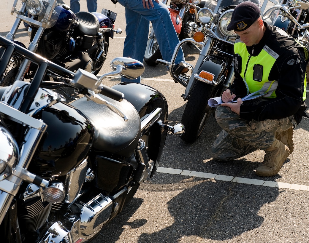 LANGLEY AIR FORCE BASE, Va. -- Staff Sgt. Brandon Phelps, 633d Security Forces Squadron unit training instructor, performs a safety inspection May 12. The motorcycle ride was part of National Police Week, a celebration in honor of law enforcement officers who lost their lives in the line of duty. (U.S. Air Force photo/Senior Airman Zachary Wolf)