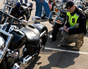 LANGLEY AIR FORCE BASE, Va. -- Staff Sgt. Brandon Phelps, 633d Security Forces Squadron unit training instructor, performs a safety inspection May 12. The motorcycle ride was part of National Police Week, a celebration in honor of law enforcement officers who lost their lives in the line of duty. (U.S. Air Force photo/Senior Airman Zachary Wolf)