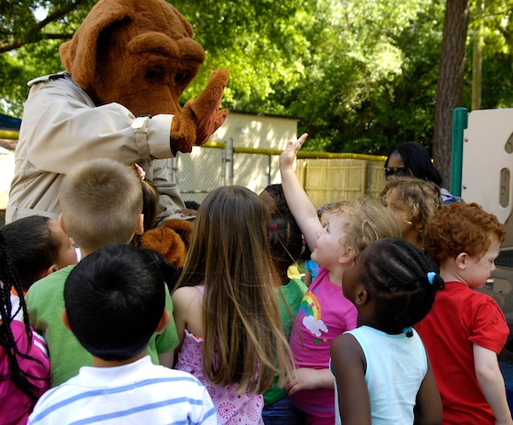 Scruff McGruff "The Crime Dog" visits the Child Development Center on Joint Base Charleston, S.C., May 10, 2010. McGruff's visit was part of National Police Week, which was established in 1982 by President John F. Kennedy. During his visit to the CDC, McGruff provided safety tips and the opportunity for children to be fingerprinted. (U.S. Air Force Photo/Airman 1st Class Lauren Main)