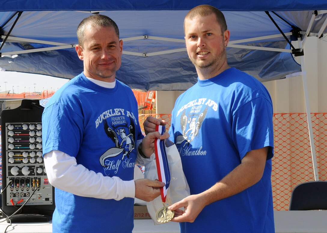 BUCKLEY AIR FORCE BASE, Colo. -- Senior Chief Petty Officer Tracy Kugle recieves his first-place medal after completing the Fourth Annual Half Marathon May 8. The Annual Half Marathon is held at Buckley Air Force Base. ( U.S. Air Force Photo by Airman 1st Class Marcy Glass )
