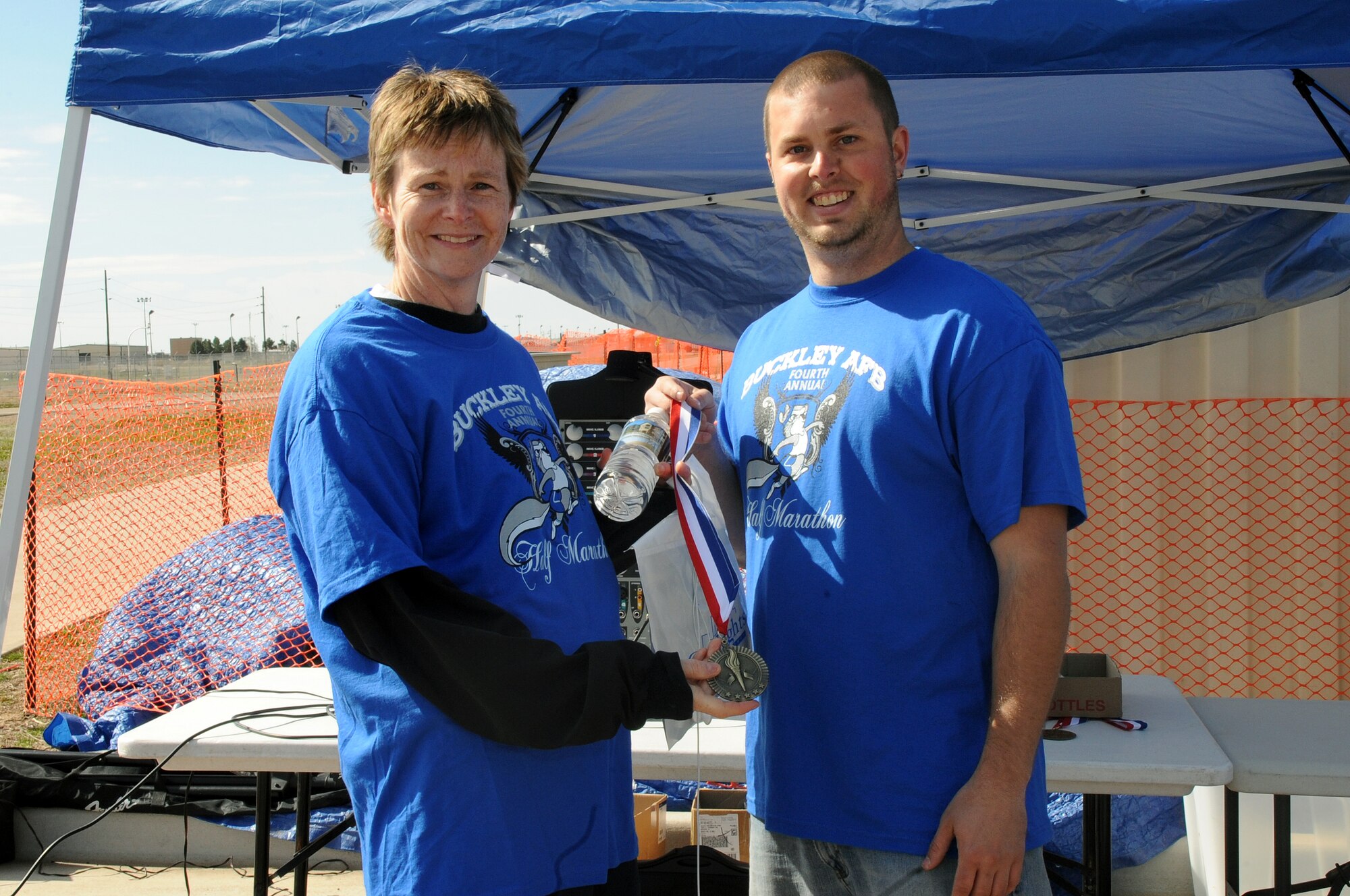 BUCKLEY AIR FORCE BASE, Colo. -- Chief Master Sgt. Gerrie McCoy recieves a medal, placing third in the female category after the Fourth Annual Half Marathon May 8 at Buckley Air Force Base. ( U.S. Air Force Photo by Airman 1st Class Marcy Glass )