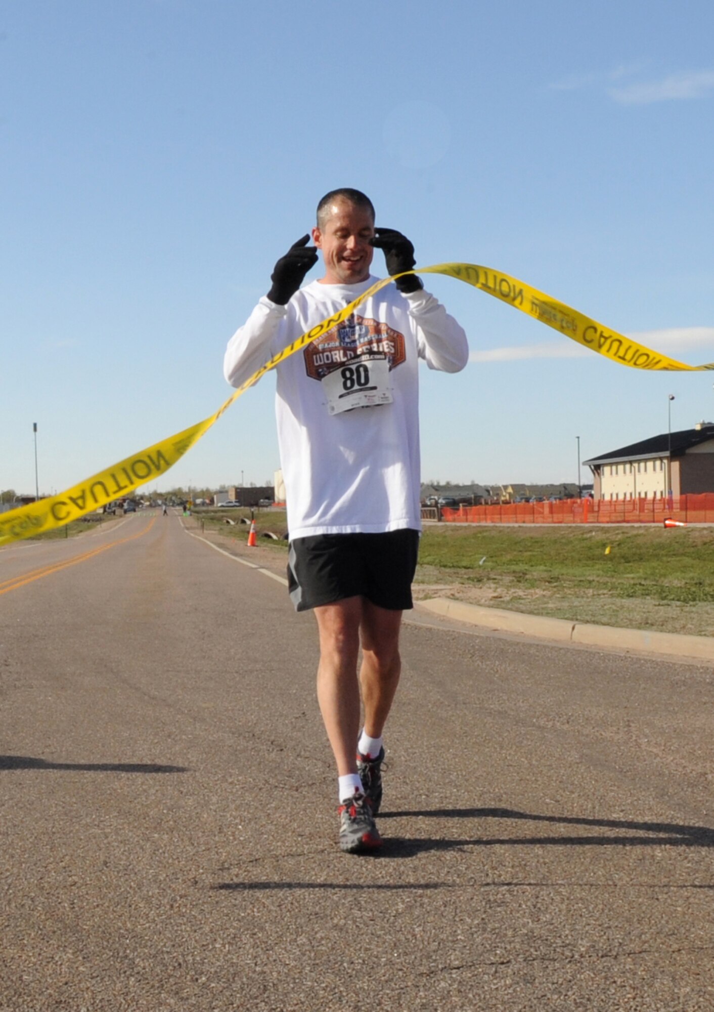 BUCKLEY AIR FORCE BASE, Colo. -- Senior Chief Petty Officer Tracy Kugle crosses the finish line during the Fourth Annual Half Marathon. ( U.S. Air Force Photo by Airman 1st Class Marcy Glass )