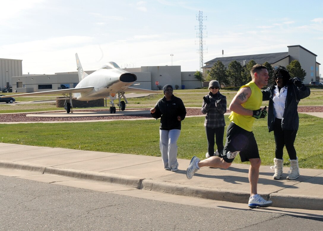 BUCKLEY AIR FORCE BASE, Colo. -- Senior Airman Jaret McGowan runs past the half way point during the 13.1 mile Annual Half Marathon. ( U.S. Air Force Photo by Airman 1st Class Marcy Glass )