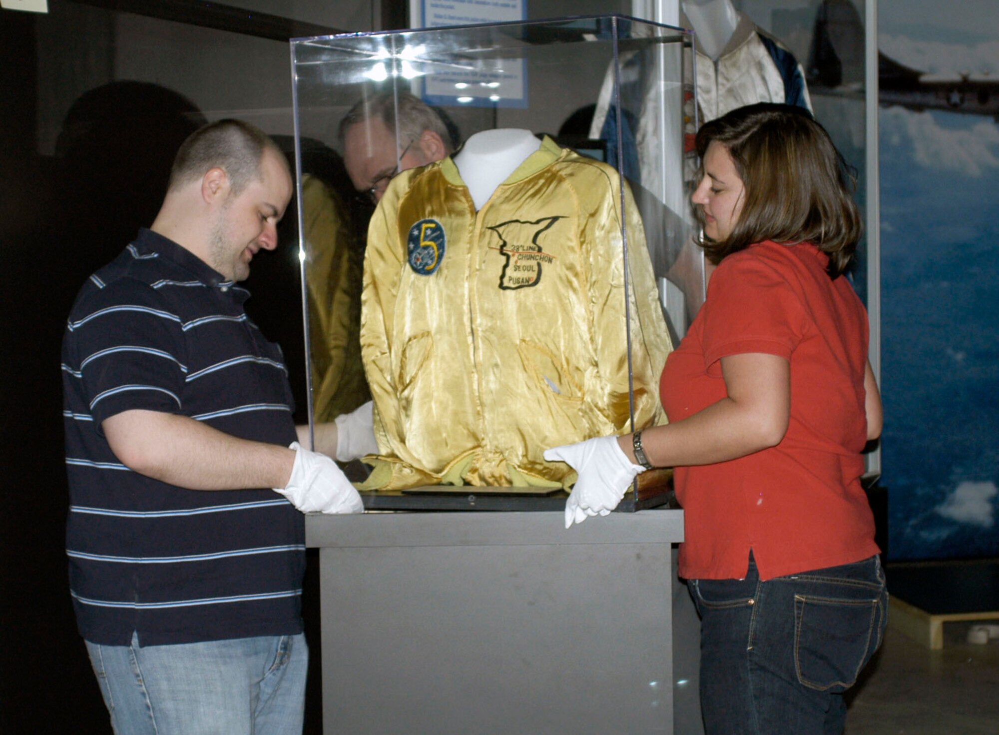 DAYTON, Ohio (05/2010) -- In preparation for the 60th anniversary of the Korean War, the National Museum of the U.S. Air Force is renovating its Korean War exhibit. Here, exhibits and collection management specialists ready an exhibit case. (U.S. Air Force photo)