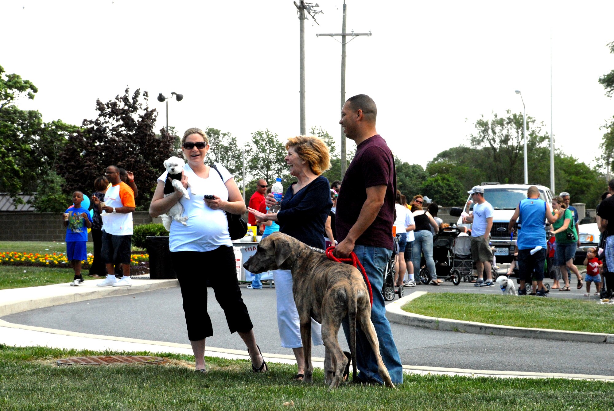 Airman 1st Class Lori Campbell, 436th Logistics Readiness Squadron, her dog Rascal and her mother Shirley Lee, talk with Master Sgt. Clarence DePass, 436th LRS and his dog Sage at the Pet Extravaganza and Block Party at Eagle Heights May 8. The Pet Extravaganza gave many pet owners a chance to come out and meet other pet owners and socialize their pets.(U.S. Air Force photo/Airman 1st Class Matthew Hubby)