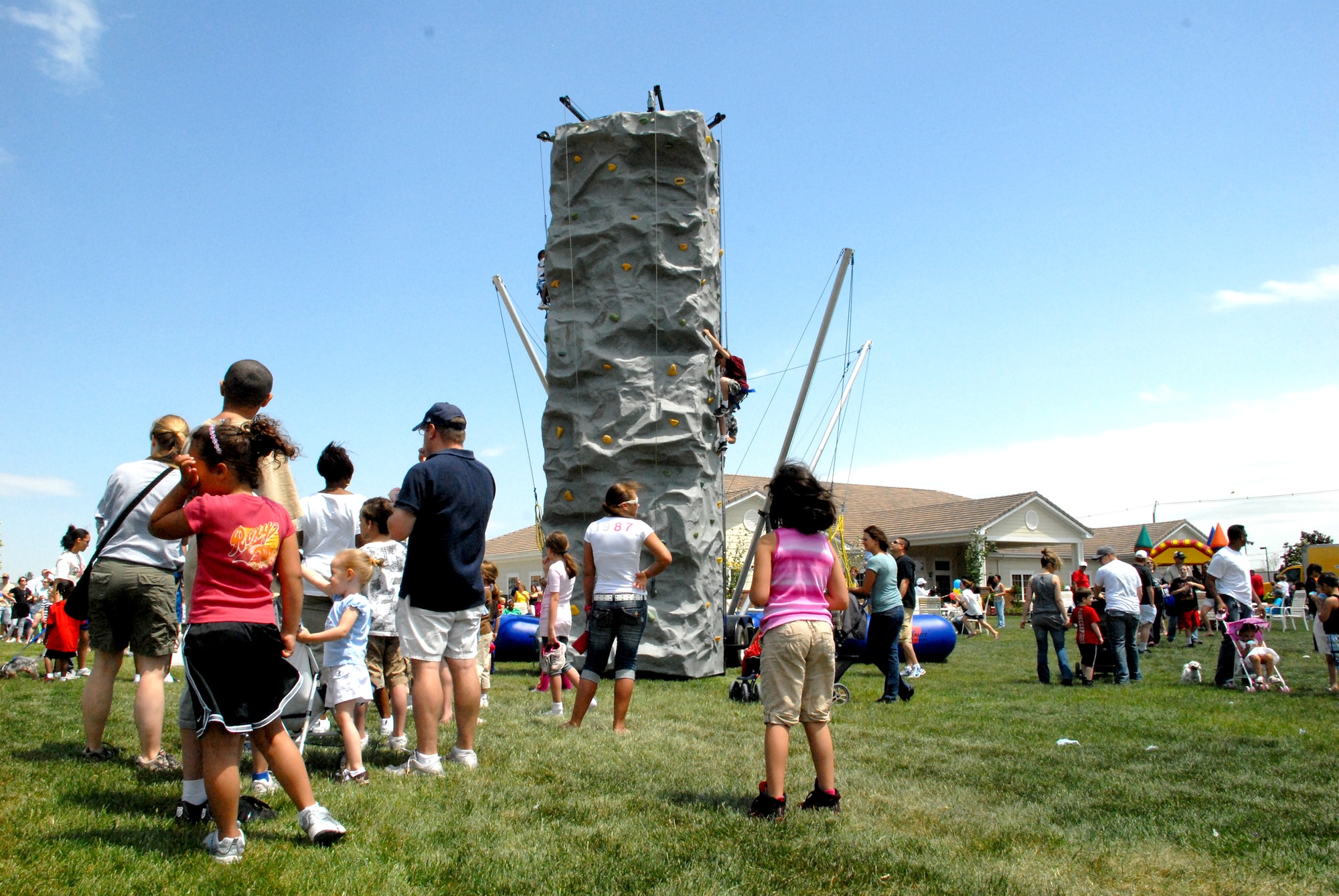 Team Dover gathers at the Eagle Heights Community Center for the Pet Extravaganza and Block Party May 8. There were many rides and attractions at the event, including a rock climbing wall, rubber band jump and moon bounce. (U.S. Air Force photo/Airman 1st Class Matthew Hubby)