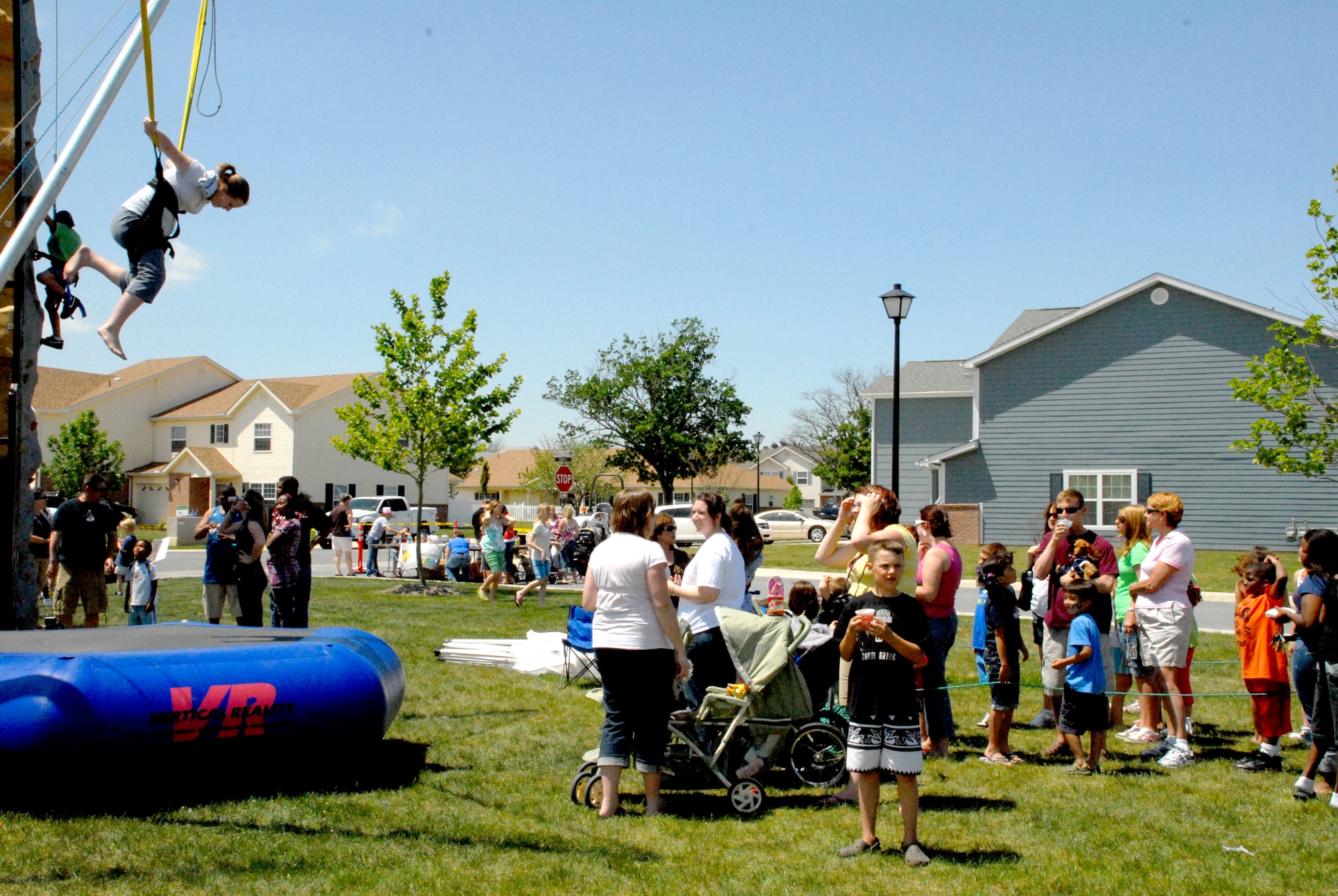 Team Dover members wait in line for the rubber band bounce during the Pet Extravaganza and Block Party at Eagle Heights May 8. There were booths and rides set up for Team Dover to enjoy the weather and events at the Block Party.  (U.S. Air Force photo/Airman 1st Class Matthew Hubby)