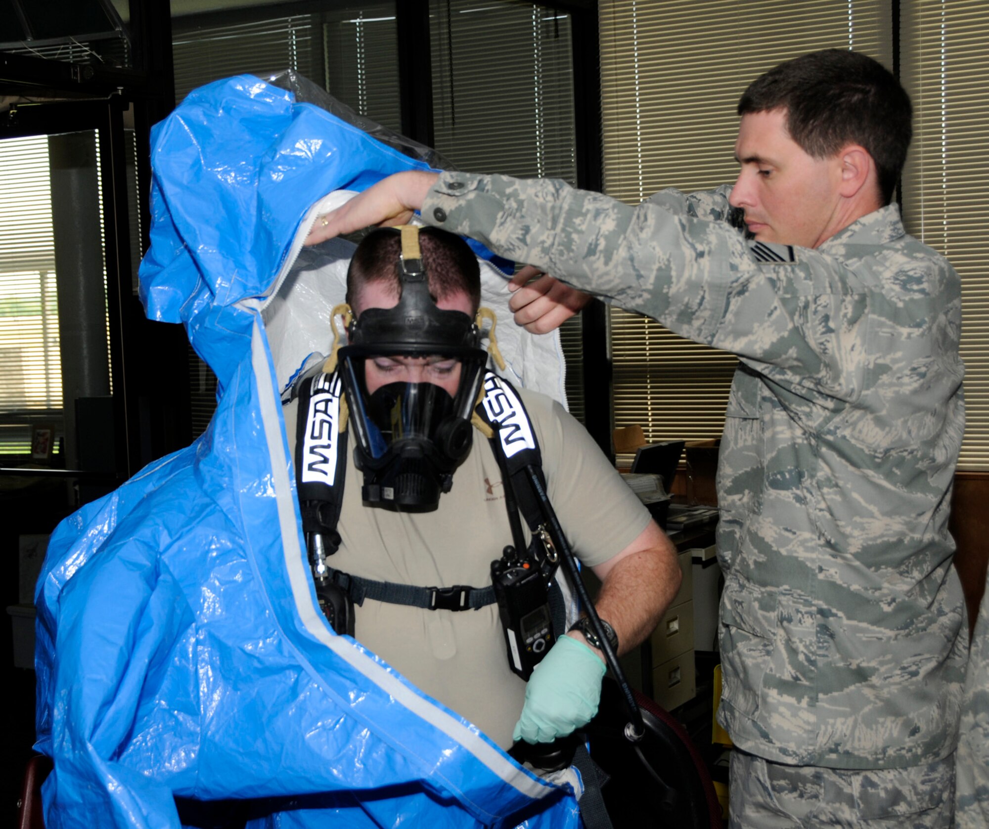 Tech Sgt. Timothy Booth of the 188th Fighter Wing, left, prepares for an exercise scenario at the 188th April 28. Booth is a member of the Air National Chemical, Biological, Radiological and Nuclear (CBRNE) Challenge Team, which trained at the 188th April 26-30  in preparation for this week’s Air Force-wide CBRNE competition held at the Center of National Response in West Virginia. (U.S. Air Force photo by Senior Master Sgt. Dennis Brambl/188th Fighter Wing Public Affairs) 