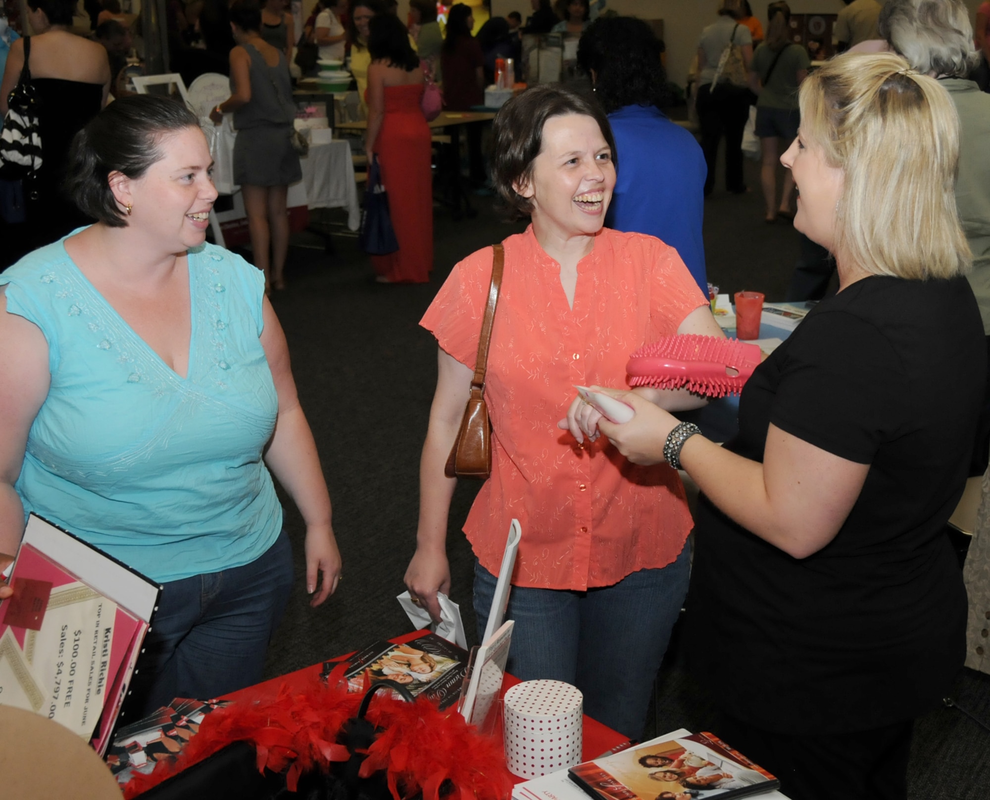 From left, Teressa Vieira and Angel Thomas chat with Lindsey Boudreaux, Slumber Parties consultant, Pamper Me Day, May 7 at the Roberts Consolidated Aircraft Maintenance Facility.  Their spouses are Tech. Sgt. Jon Vieira, 81st Logistics Readiness Squadron; Master Sgt. Alan Thomas, 333rd Training Squadron; and Staff Sgt. Barry Boudreaux, 81st Training Support Squadron. The annual event sponsored by the airman and family readiness center featured agencies, vendors, giveaways, activities, business and product displays and information booths.   (U.S. Air Force photo by Kemberly Groue)