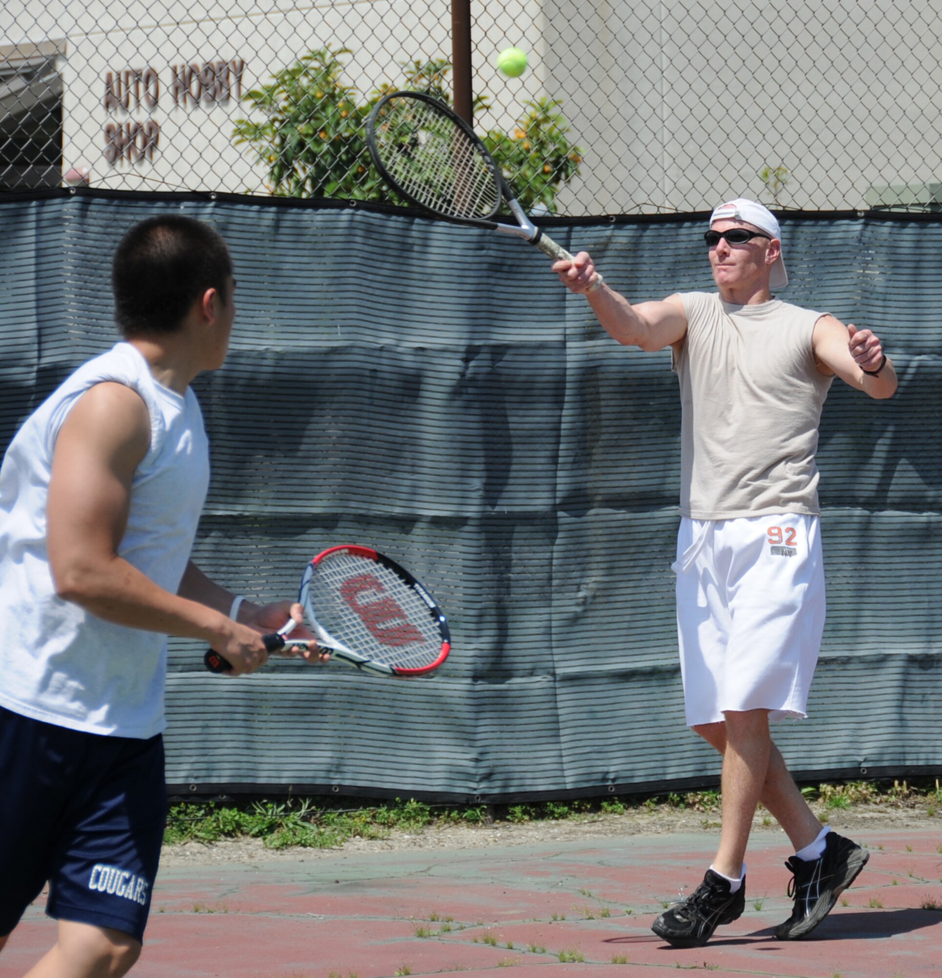 Carlo Sumagui, left, and Gerald Cross are teammates from the 81st Force Support Squadron in a Sports Day tennis match against the 81st Medical Support Squadron, May 7.  (U.S. Air Force photo by Kemberly Groue)