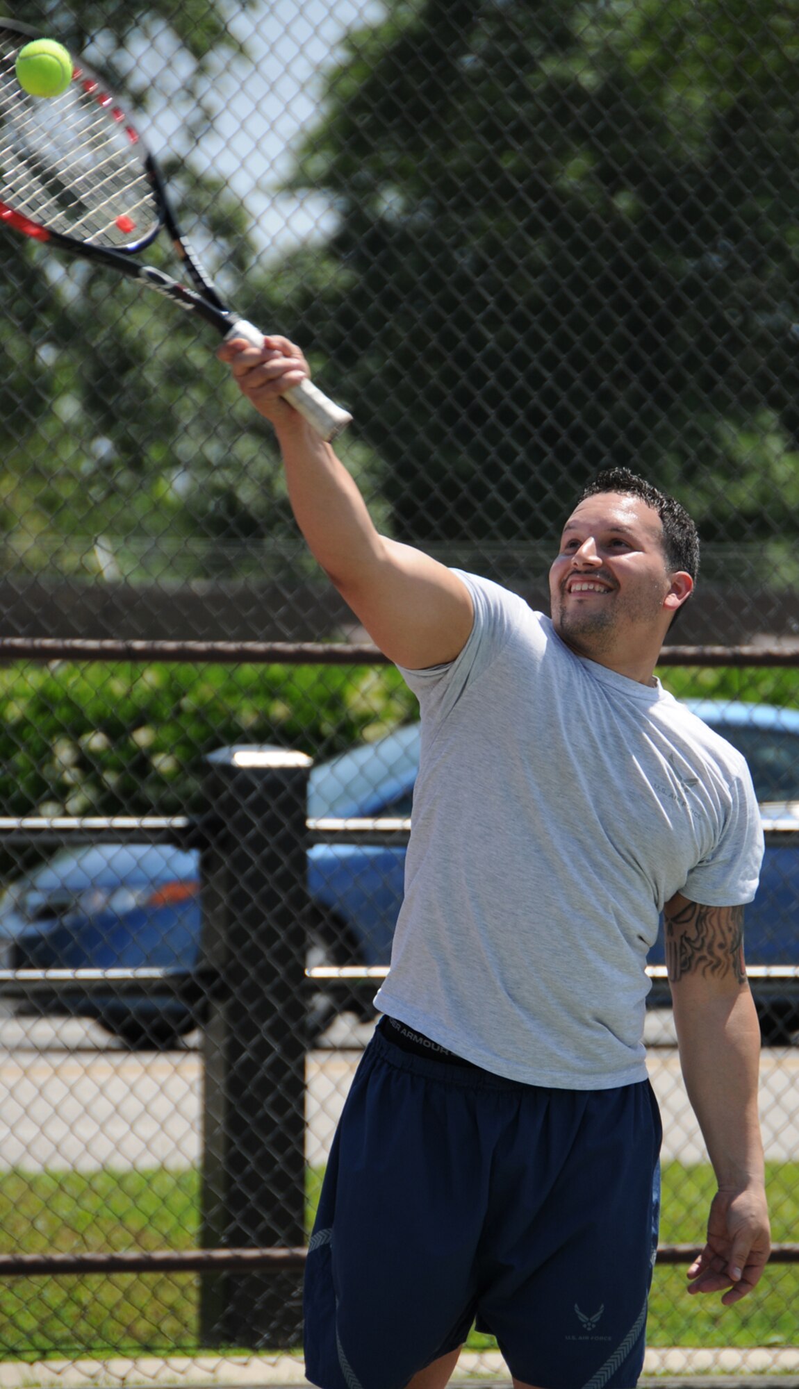 Andre Torres, 81st Medical Support Squadron, makes a serve during a tennis match during Sports Day, May 7.  (U.S. Air Force photo by Kemberly Groue)