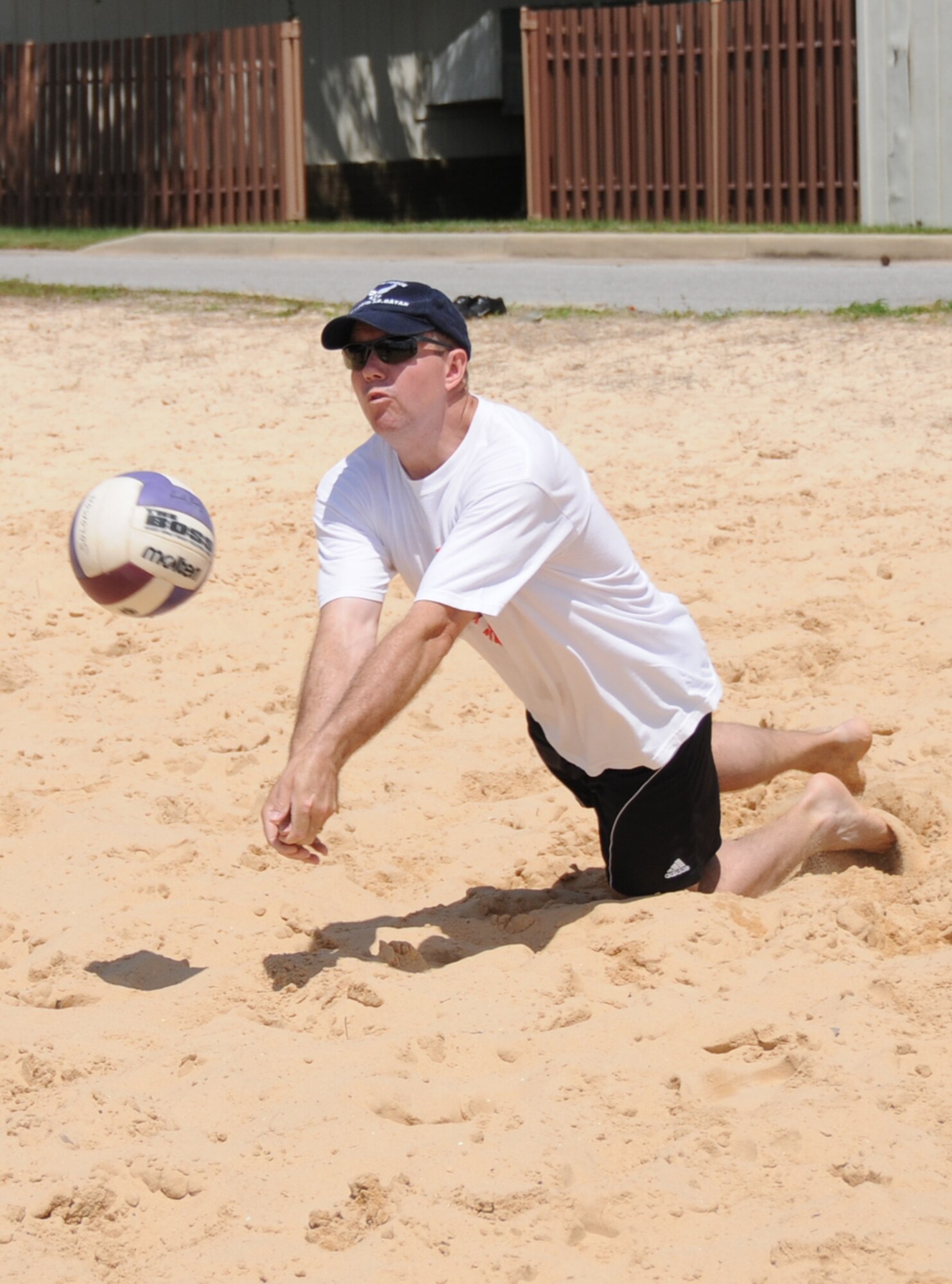 Scott Solomon, 333rd Training Squadron, makes a diving hit during a Sports Day volleyball match, May 7.  (U.S. Air Force photo by Kemberly Groue)