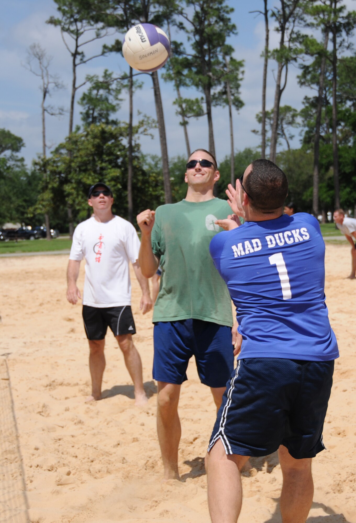 From left, 333rd Training Squadron teammates Scott Solomon, Joel Peebles and Richard Striggow play volleyball during Sports Day against the 81st Medical Support Squadron, May 7.  (U.S. Air Force photo by Kemberly Groue)