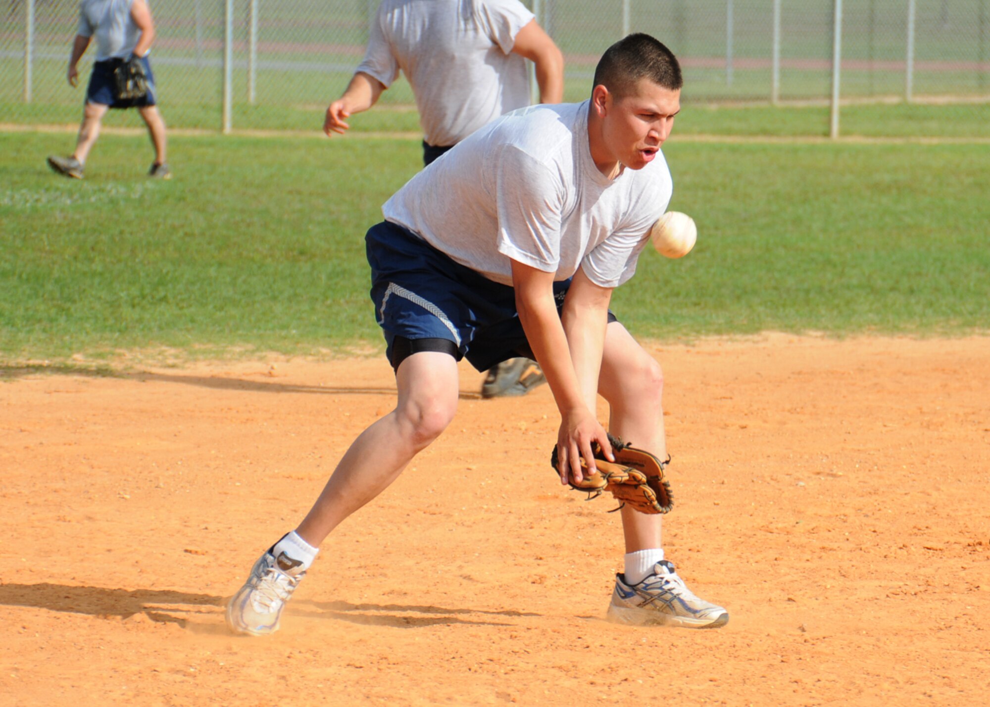 Third baseman Kenneth Littlewolf, 81st Logistics Readiness Squadron, tries to gain control of the ball in a softball game during Sports Day, May 7.  The 81st LRS beat the 336th Training Squadron, 16-12.  (U.S. Air Force photo by Kemberly Groue)