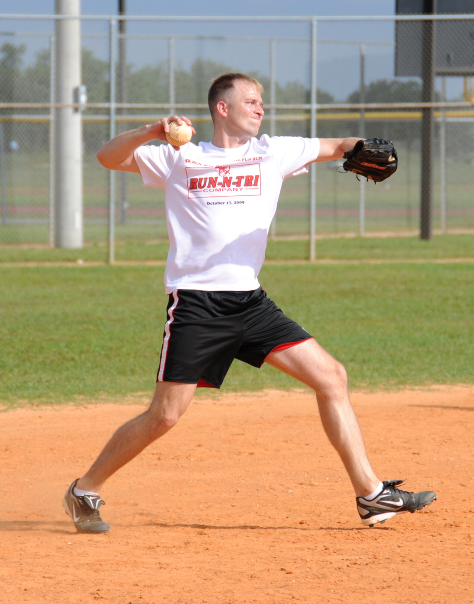 Third baseman James Desgrange, 336th Training Squadron, makes a throw to first base in a softball game during Sports Day, May 7.  The 81st Logistics Readiness Squadron beat the 336th TRS, 16-12.  (U.S. Air Force photo by Kemberly Groue)