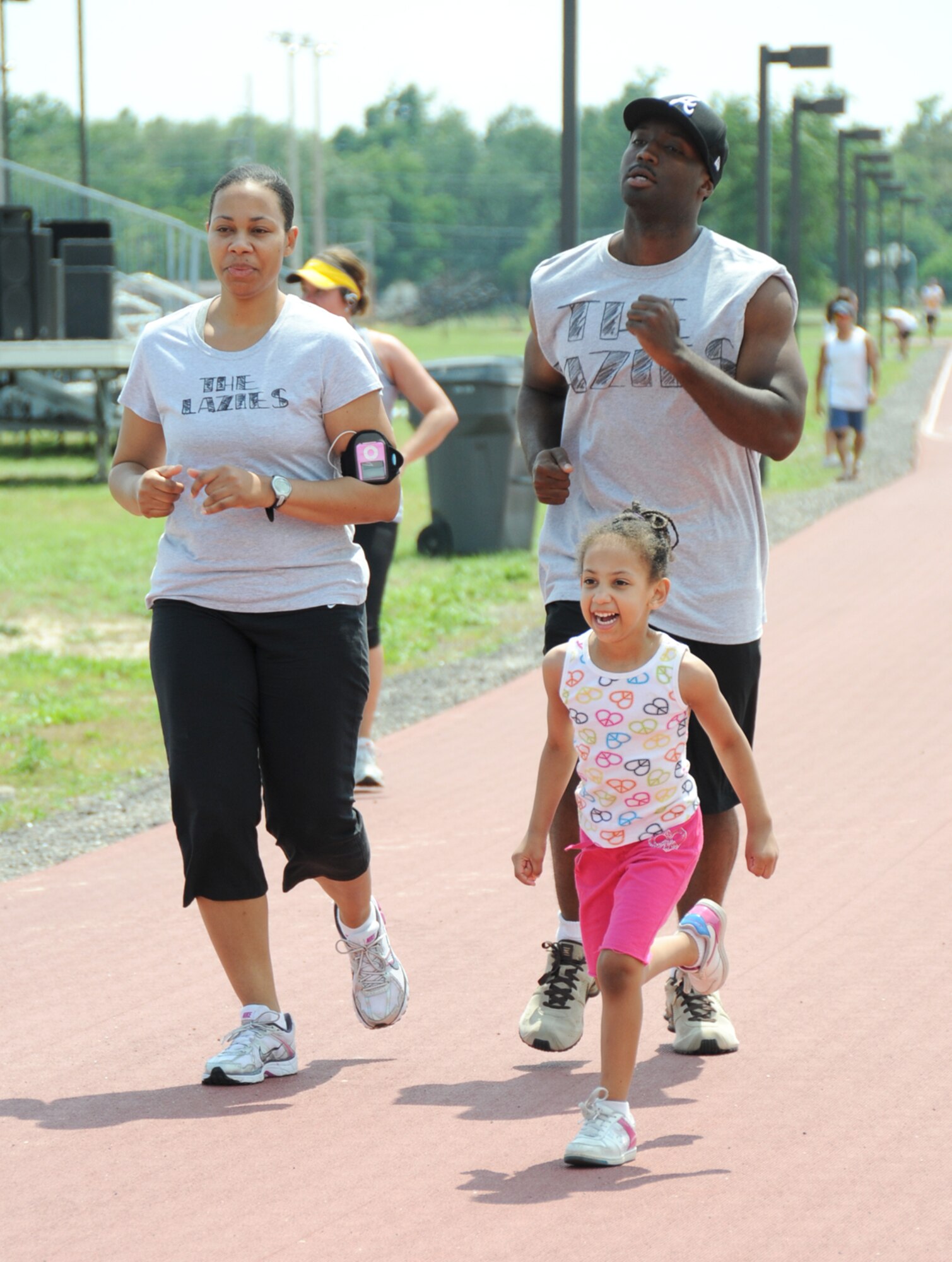 Shiree Holder and her wingman, Michael Young, staff sergeants from the 334th Training Squadron, are paced by Sergeant Holder’s 4-year-old daughter, Alaina, at Saturday’s Dragon Challenge at the Triangle track.  The 12-hour marathon event, sponsored by Keesler 5/6, benefits Fisher House.  The funds raised are still being totaled.  (U.S. Air Force photo by Kemberly Groue)