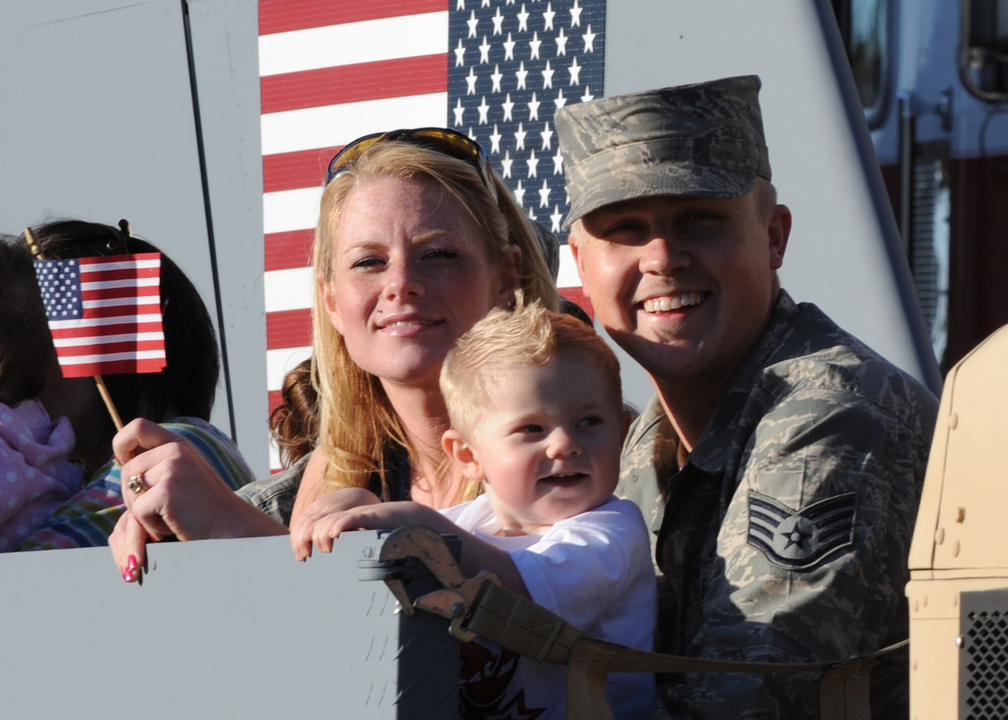 Team McConnell family members participate in Wichita’s Sundown Parade May 7, 2010, downtown Wichita, Kan. Family members of deployed spouses were encouraged to ride the new float created by Airmen of the 22nd Maintenance Squadron fabrication flight and the 22nd Operations Support Squadron. (U.S. Air Force photo/Airman 1st Class Andrea Salazar)