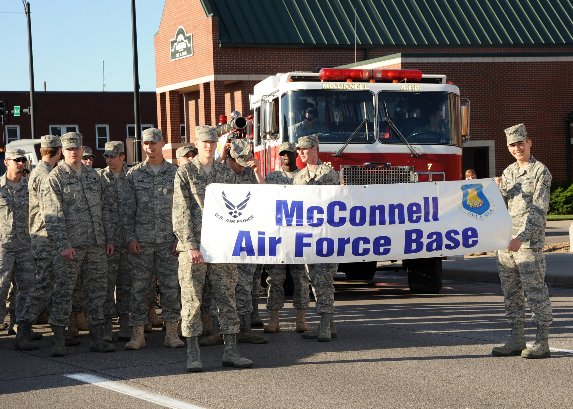 Team McConnell Airmen carry the base’s banner during the annual Sundowner Parade for Wichita’s River Festival May 7, 2010, downtown Wichita, Kan. It is tradition for the two youngest Airmen to have the honor of holding the banner for events to display community support. McConnell’s participation allows the local community to see up close diverse the faces of Team McConnell. (U.S. Air Force photo/Airman 1st Class Andrea Salazar)