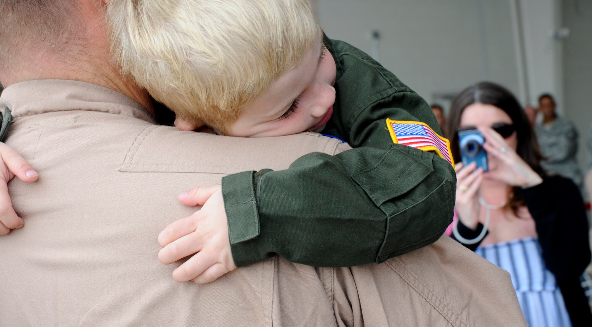 Evan Summerlin hugs his father Maj, Josh Summerlin, 16th Special Operations Squadron, during a welcome home at Cannon Air Force Base May 8. Operation Homecoming greeted Cannon Airmen who returned from overseas deployments.  (U.S. Air Force Photo by Senior Airman Evelyn Chavez)