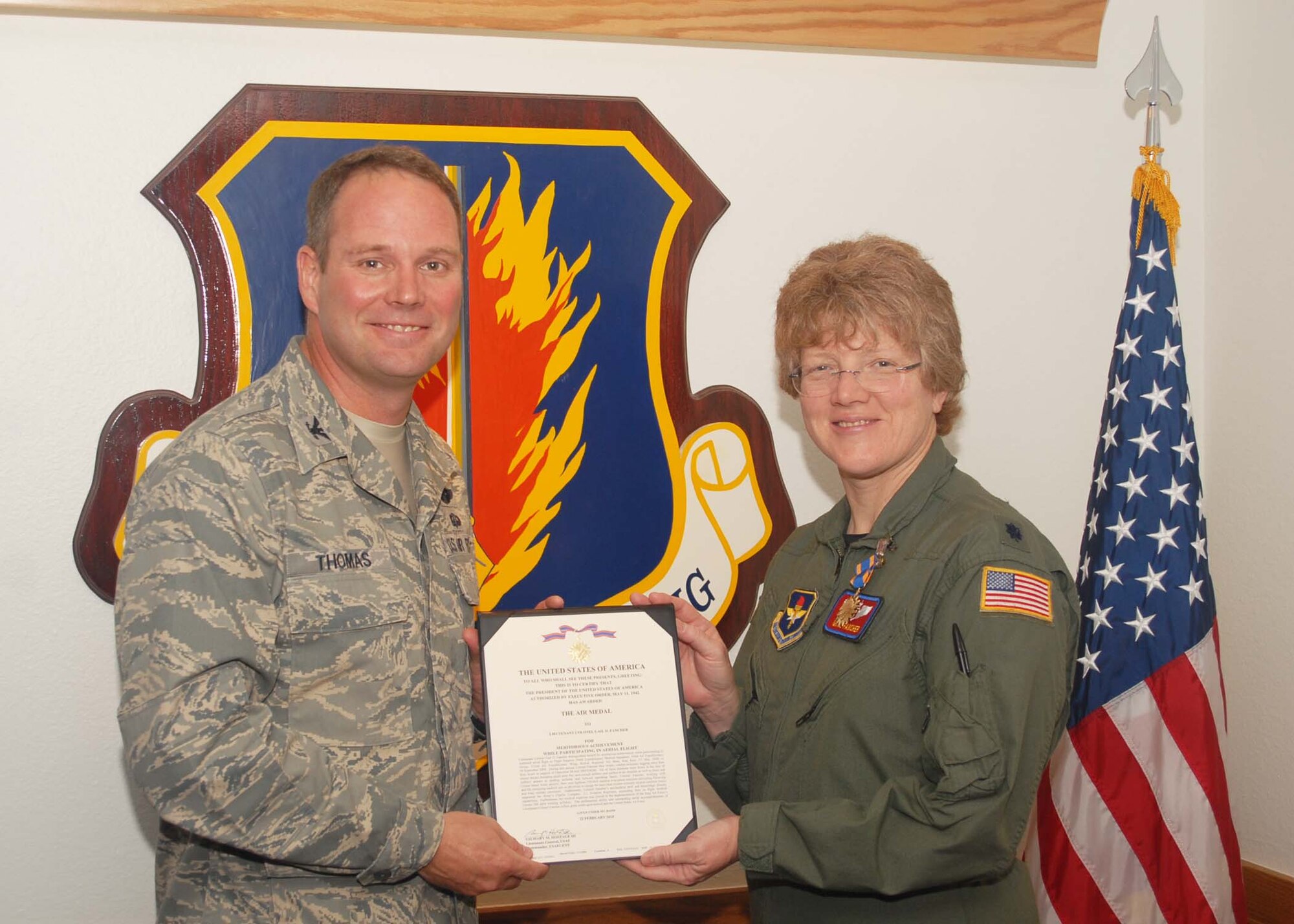 ALTUS AIR FORCE BASE, Okla.- Col. Ty Thomas presents the Air Medal to Lt.
Col. Fancher at the Wing Staff on April 13, 2010. Lt. Col. Fancher received
the Air Medal for meritorious achievement as a flight surgeon. ( U.S. Air
Force photo by Airman 1st Class Christopher Arnold/Release 97th Air Mobility
Wing Public Affairs)
