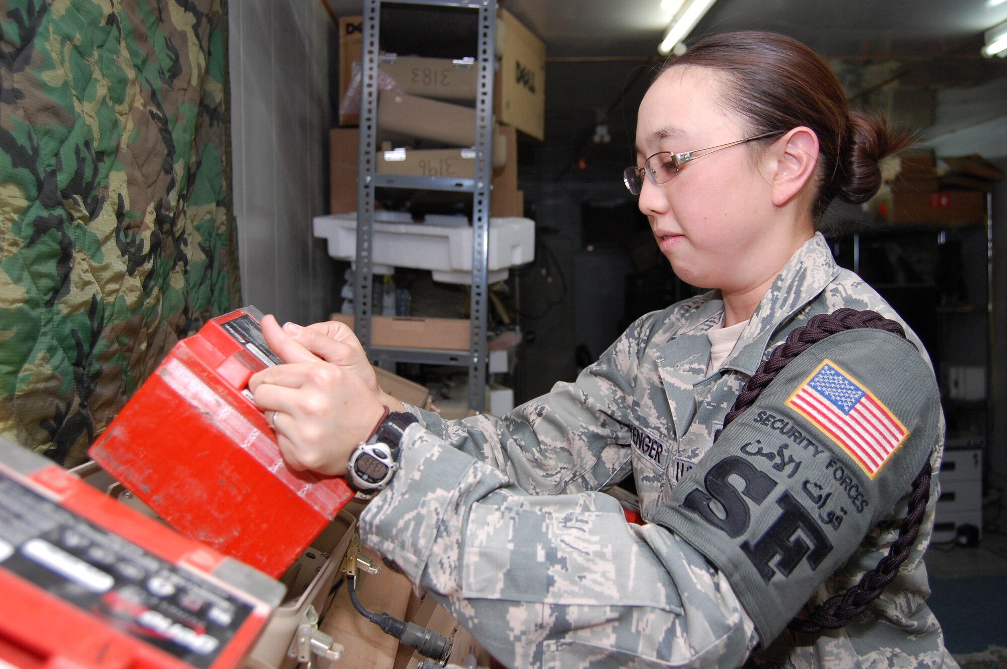 U.S. Air Force Staff Sgt. Kelly Clevenger, 386th Expeditionary Security Forces Squadron tactical automated security system and investigations NCO in charge, recharges a battery for a TASS sensor used to detect entrusions around the base May 11, 2010 at an air base in Southwest Asia. Sergeant Clevenger is a Sacramento, Calif. native deployed from Randolph Air Force Base, Texas. (U.S. Air Force photo by Staff Sgt. Lakisha A. Croley/Released)