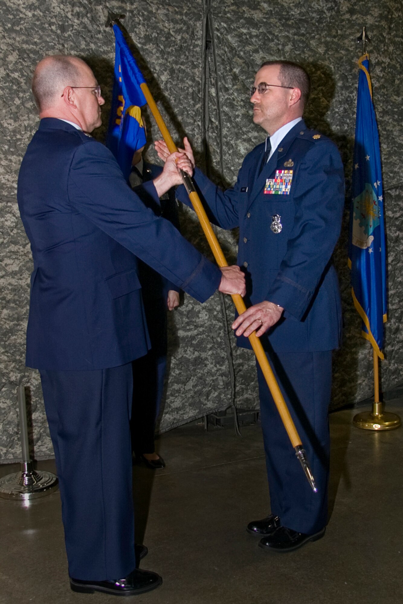 GRISSOM AIR RESERVE BASE, Ind. -- Lt. Col. Daniel Harrison, 434th Mission Support Flight commander, passes the 434th Security Forces Squadron flag to Maj. Christopher Witter as he assumes command during the May unit training assembly. Major Witter comes to Grissom from the 213th Space Warning Squadron at Clear Air Force Station, Alaska. (U.S. Air Force photo/Tech. Sgt. Mark R. W. Orders-Woempner)