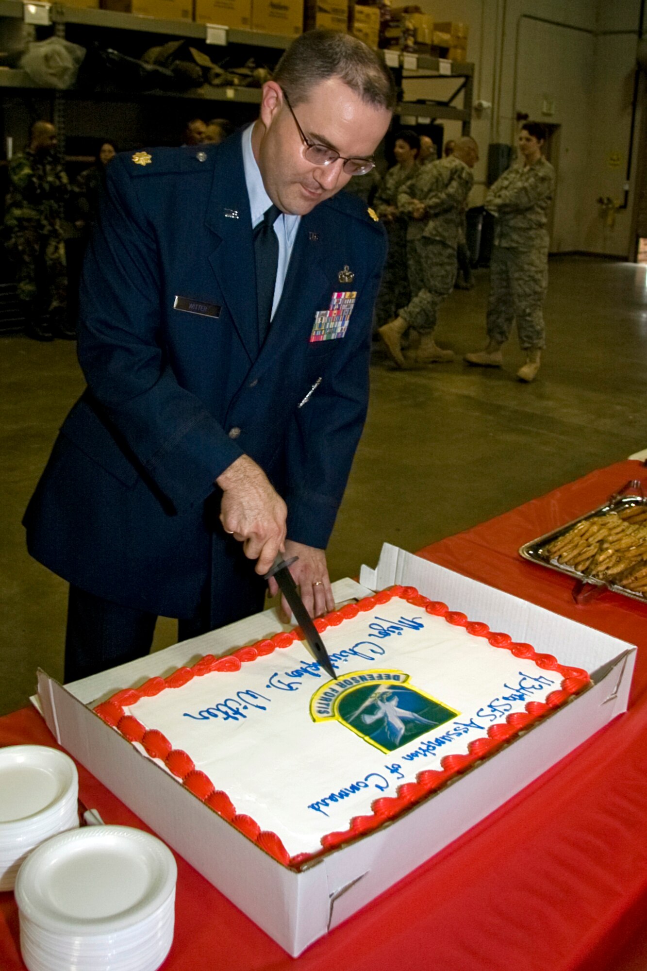 GRISSOM AIR RESERVE BASE, Ind. -- Maj. Christopher Witter, 434th Security Forces Squadron commander, cuts his cake with a military issue bayonet following his assumption of command ceremony held during the May unit training assembly. Major Witter comes to Grissom from the 213th Space Warning Squadron at Clear Air Force Station, Alaska. (U.S. Air Force photo/Tech. Sgt. Mark R. W. Orders-Woempner)