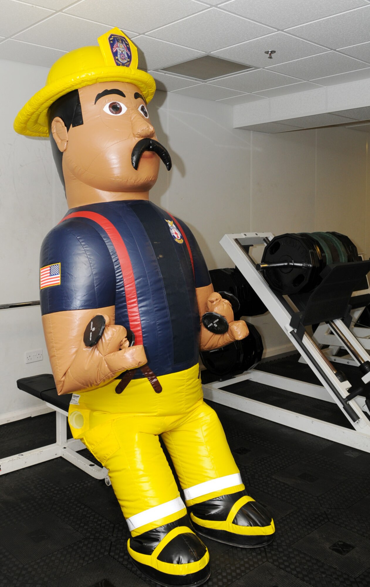 Firefighter Gary, the newest addition to the 100th Civil Engineer Squadron Fire Department, works out in the fire station gym. Though he is unable to lift large weights, Gary does lots of repetitions on the free weights and weight machines. He also likes to water ski. (U.S. Air Force photo by Karen Abeyasekere)