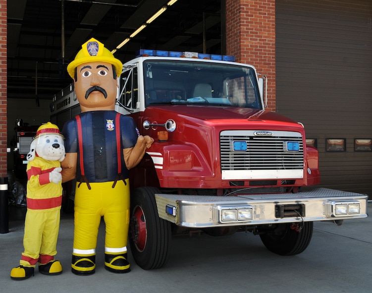Firefighter Gary, right, is the newest member of the 100th Civil Engineer Squadron Fire Department, and good buddies with seasoned fire dog, Sparky. Gary is part of the fire prevention team and will visit events with Sparky and his firefighter friends, to spread the message about fire prevention. When asked about his views on fire safety, Firefighter Gary said, "No matter how big or small, fire prevention matters to us all! Stay safe!" (U.S. Air Force photo by Karen Abeyasekere)