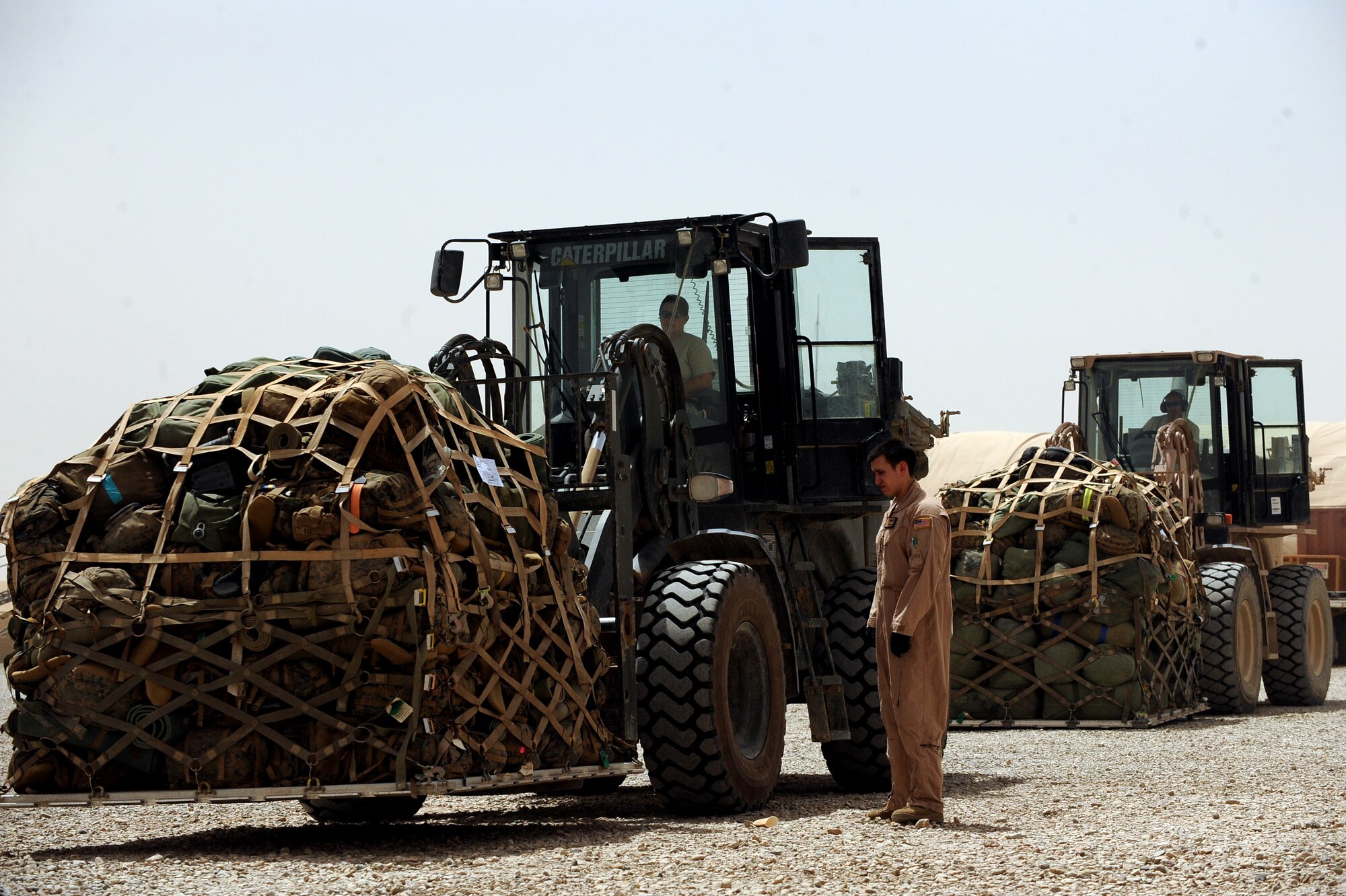 Senior Airman Glenn Bernier II, a C-17 Globemaster III loadmaster assigned to 817th Expeditionary Airlift Squadron, directs an aerial porter assigned to the 451st Expeditionary Logistics Readiness Squadron's Detachment 1, while loading cargo, April 20, 2010, at Camp Bastion, Afghanistan. ?Every time we land here we see the Aerial Porters and they are on it; we are able to get our cargo offloaded fast,? said Senior Airman Glenn Bernier II, a C-17 loadmaster with the 817th EAS at the Transit Center at Manas, and deployed from Travis Air Force Base, Calif. ?It'is impressive to see and it makes you proud to see your fellow Airmen on the ground when you land. It makes you feel a part of something bigger than yourself. With every delivery we are helping our coalition partners on the ground and Afghan citizens.? (U.S. Air Force photo/Staff Sgt. Manuel J. Martinez/released)