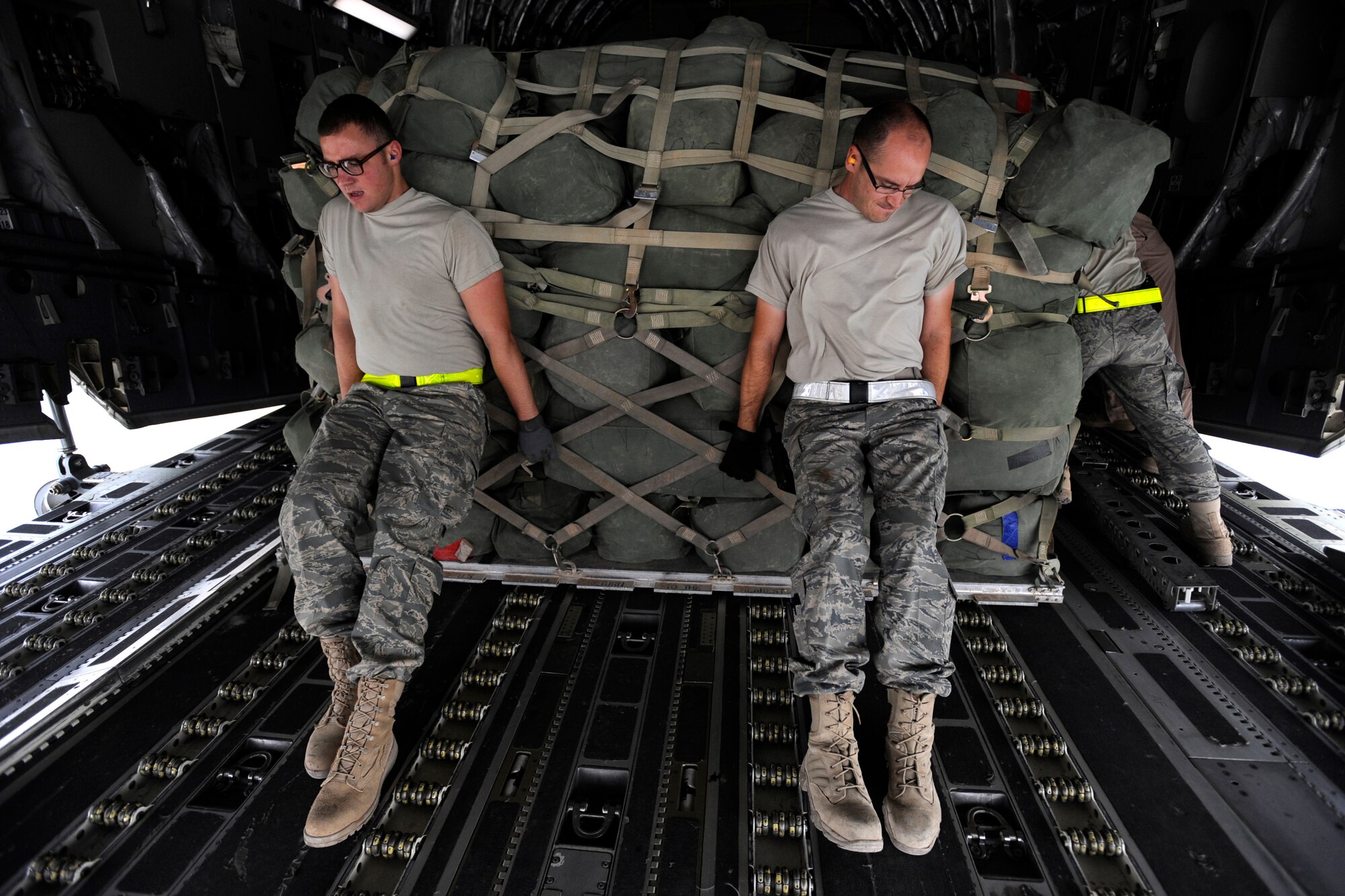 Senior Airman Curtis Whited, left, and Tech Sgt. Homer Gee, both aerial porters assigned to 451st Expeditionary Logistics Readiness Squadron Det. 1, push a pallet into a C-17 Globemaster III, April 20, 2010, at Camp Bastion, Afghanistan.  Airmen from the 451st ELRS Det. 1, have uploaded and downloaded more than 40,000 short-tons of cargo from almost 3,000 aircraft moving in and out of the Camp Bastion Airfield since January 1. (U.S. Air Force photo/Staff Sgt. Manuel J. Martinez/released)